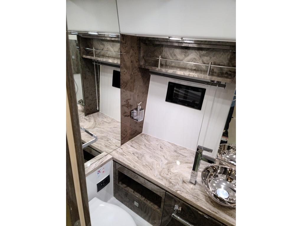 Luxurious bathroom interior of 2021 Cobrey 33 HT yacht with marble countertop and modern fixtures.