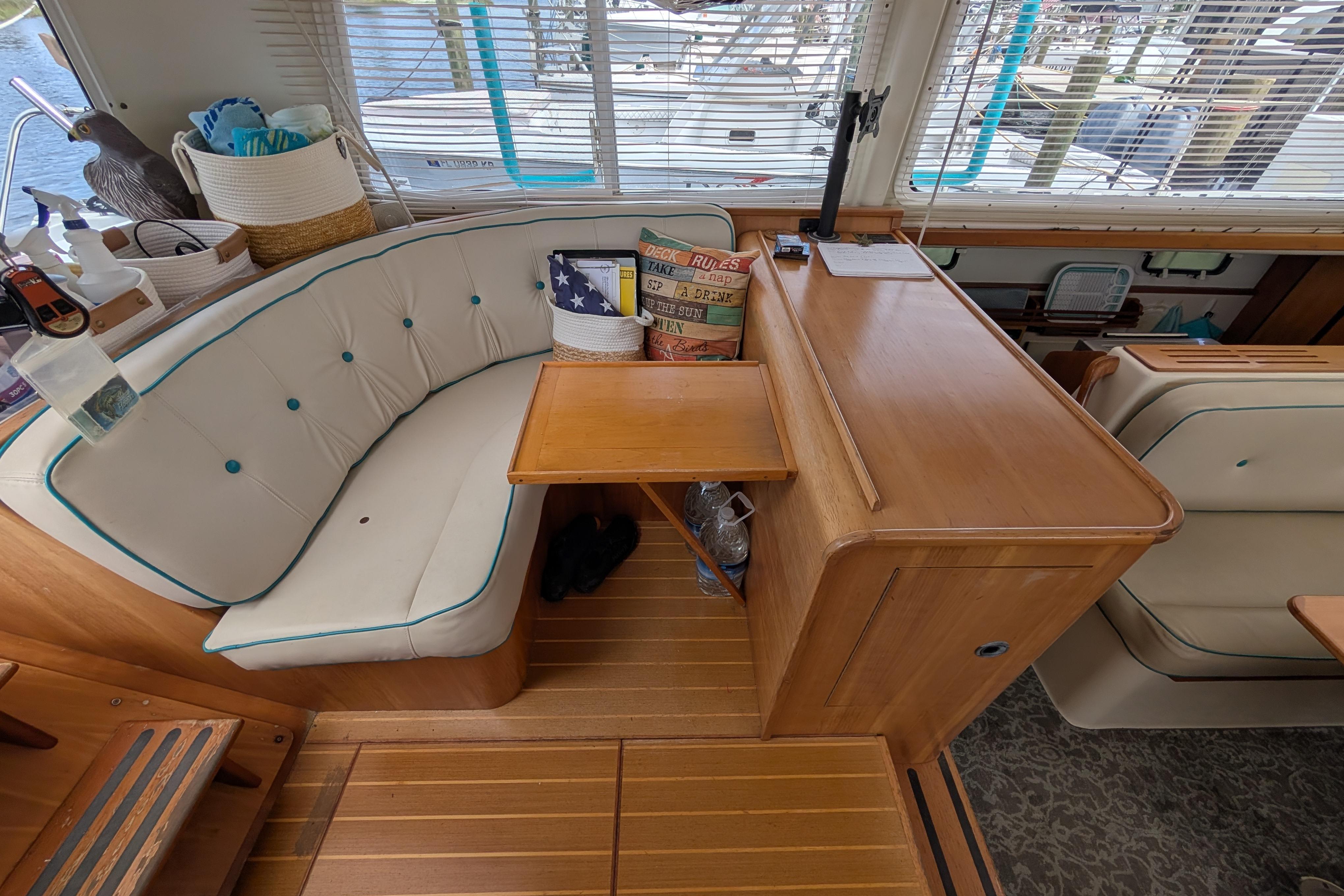 Interior of 2004 PDQ 34 Powercat with cozy seating and wooden accents.