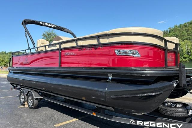 2025 Regency 250 DL3 pontoon boat with red and black design on a trailer.