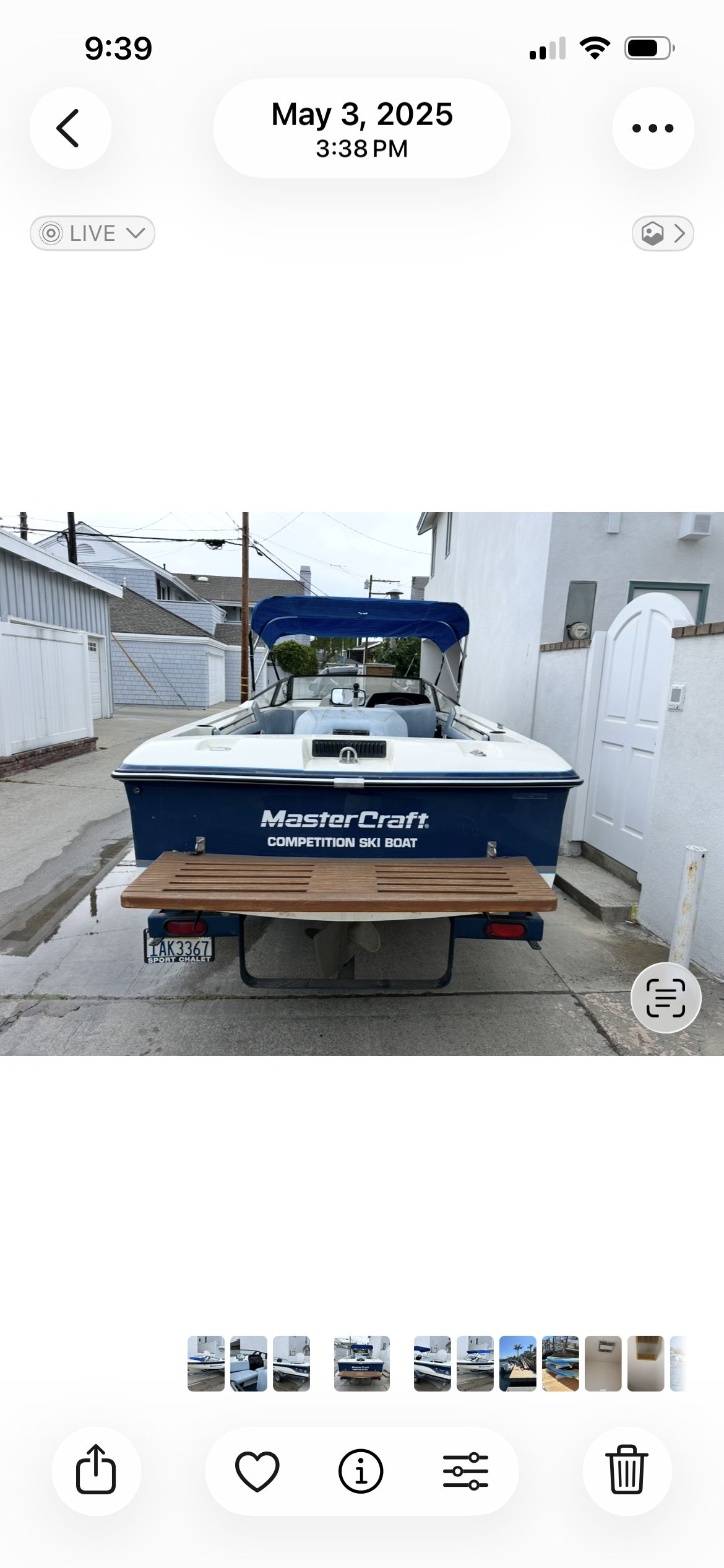 Rear view of a blue MasterCraft ProStar 190 boat on a trailer in an alley.