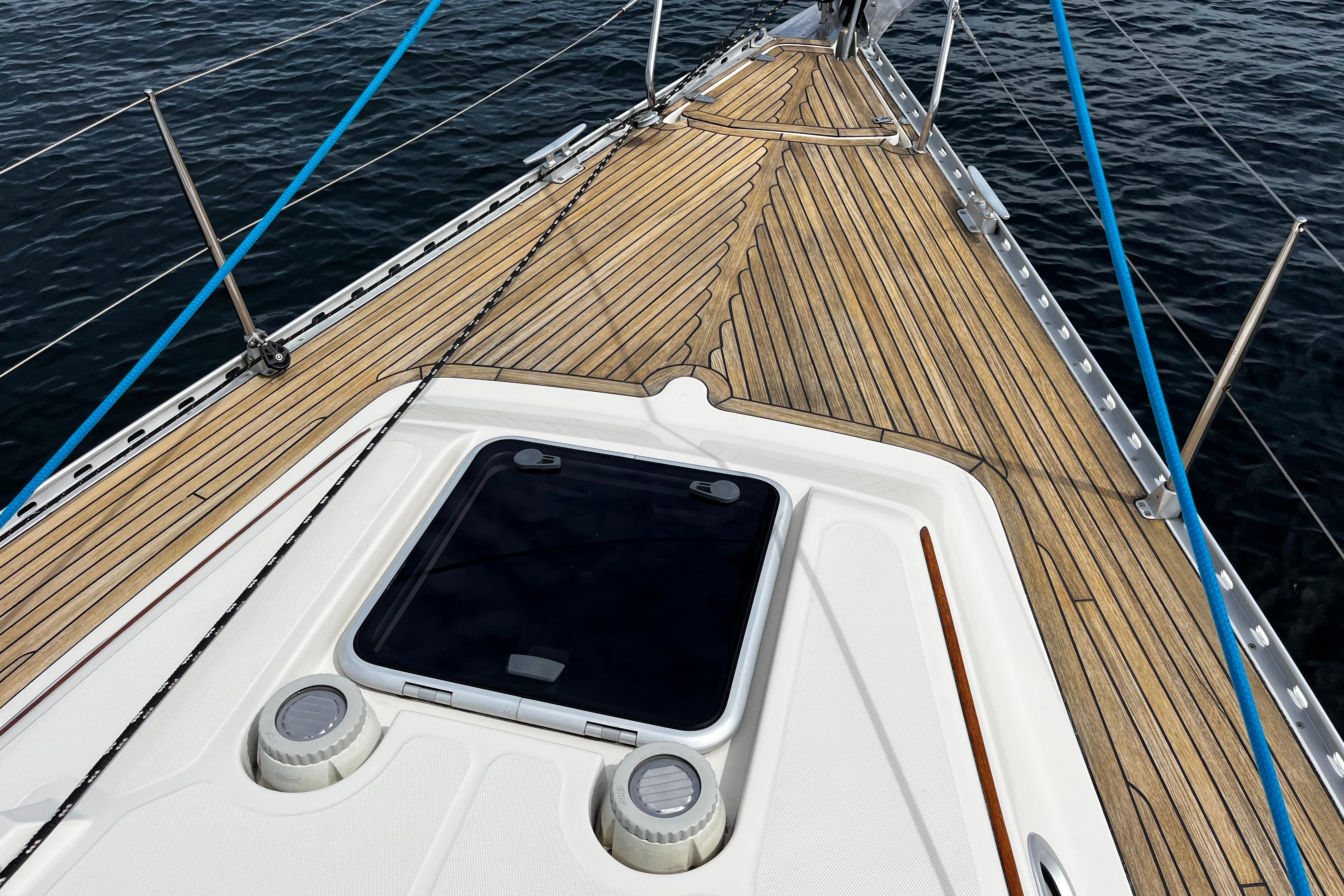 Deck of 2004 Hanse 411 sailboat with wooden finish and ocean view.