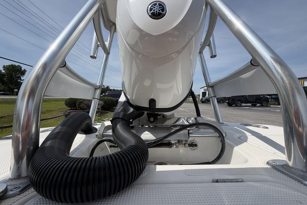 2012 Chaos 16 Bonefish boat engine close-up with metal framework and hoses.
