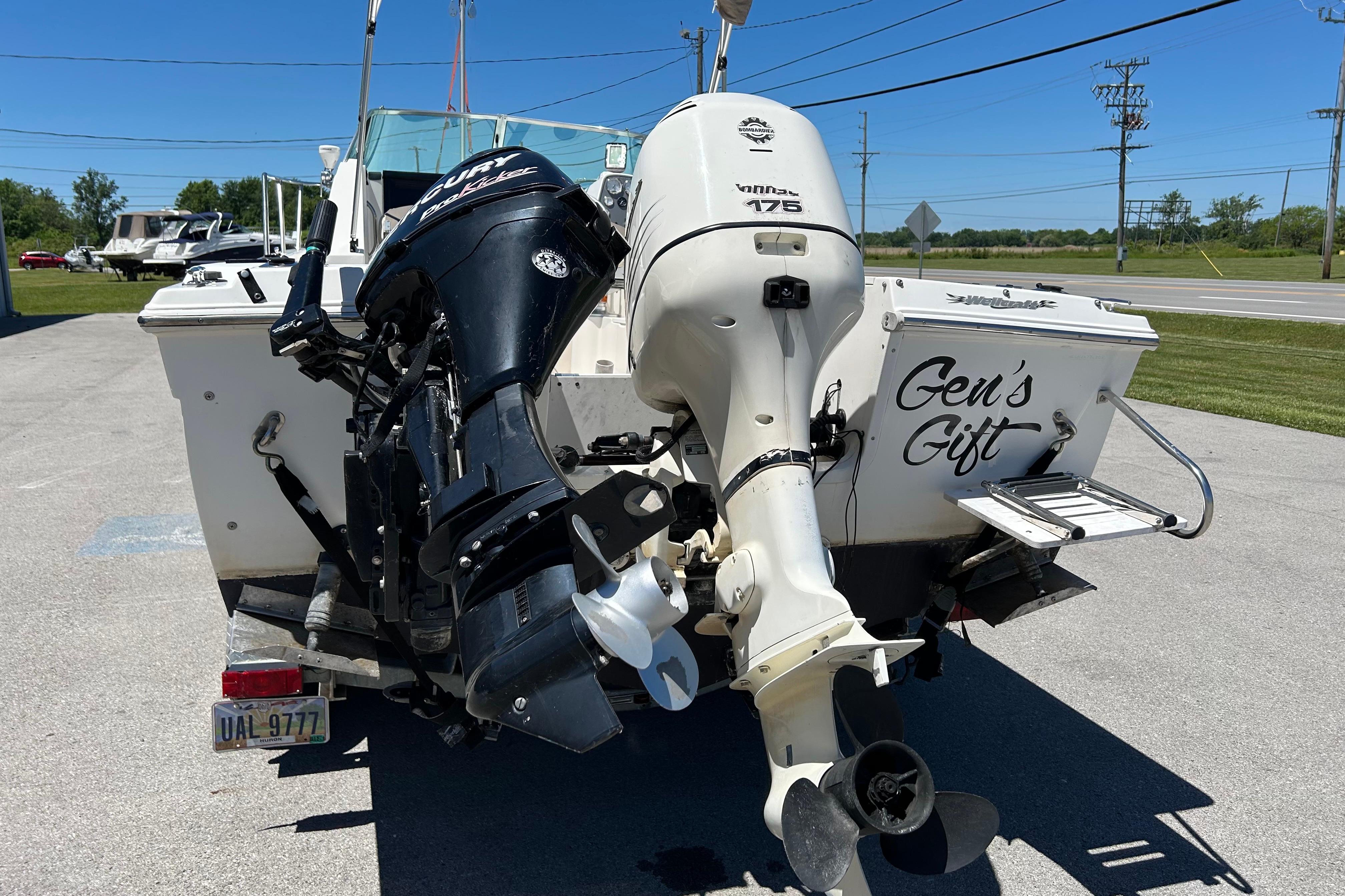 2003 Wellcraft 220 Coastal boat with dual outboard motors, labeled "Gen's Gift."