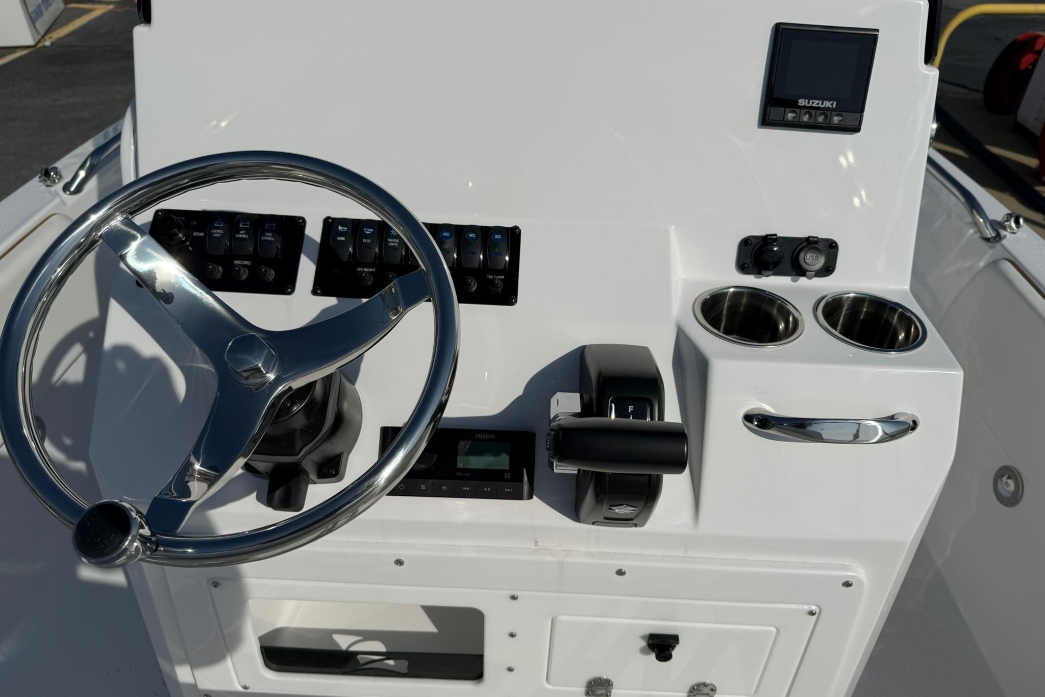 2026 Stingray 173 CC boat console with steering wheel, controls, and cup holders.