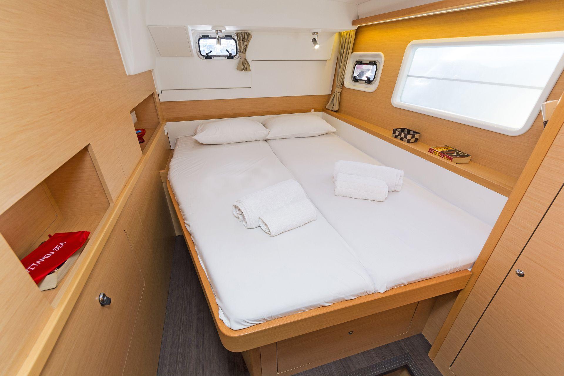 Luxurious cabin interior of 2017 Lagoon 400 S2 yacht with cozy bedding.