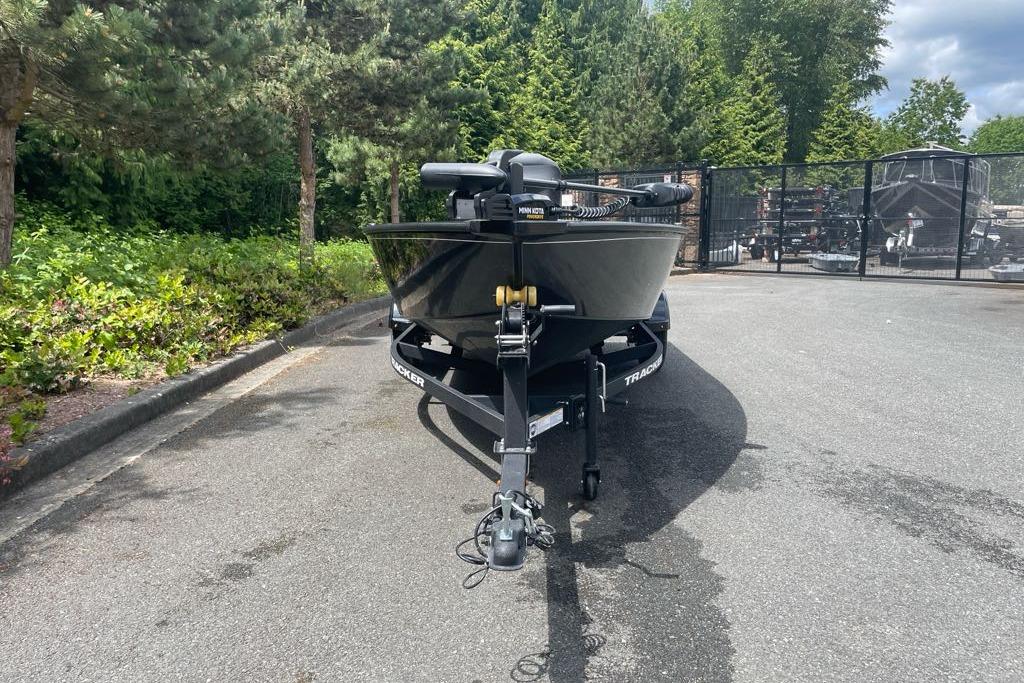 2025 Tracker Super Guide V-16 T boat on trailer, parked outdoors.