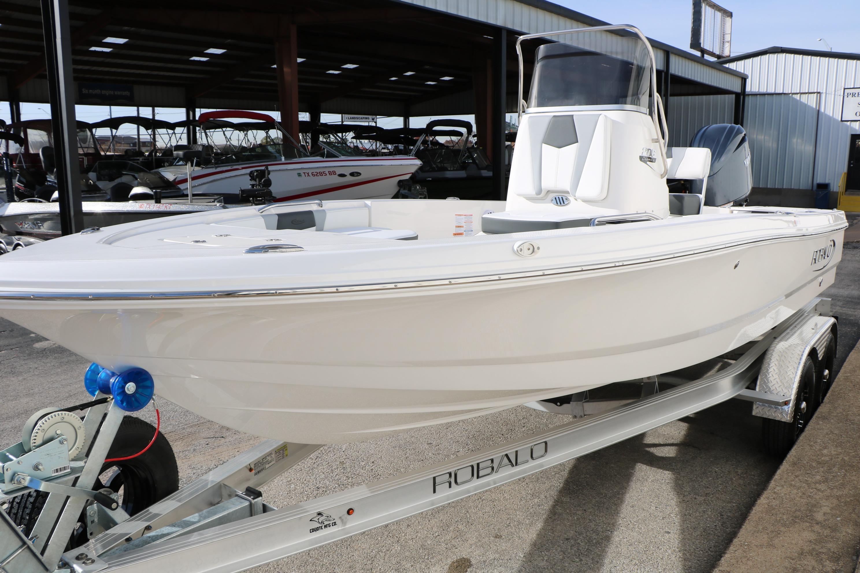 2026 Robalo 206 Cayman boat on trailer, displayed in a showroom setting.