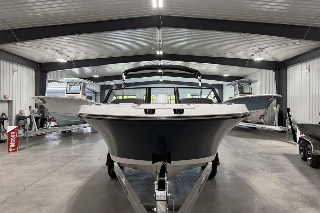 2027 Stingray 20 SBX boat in a showroom, front view.