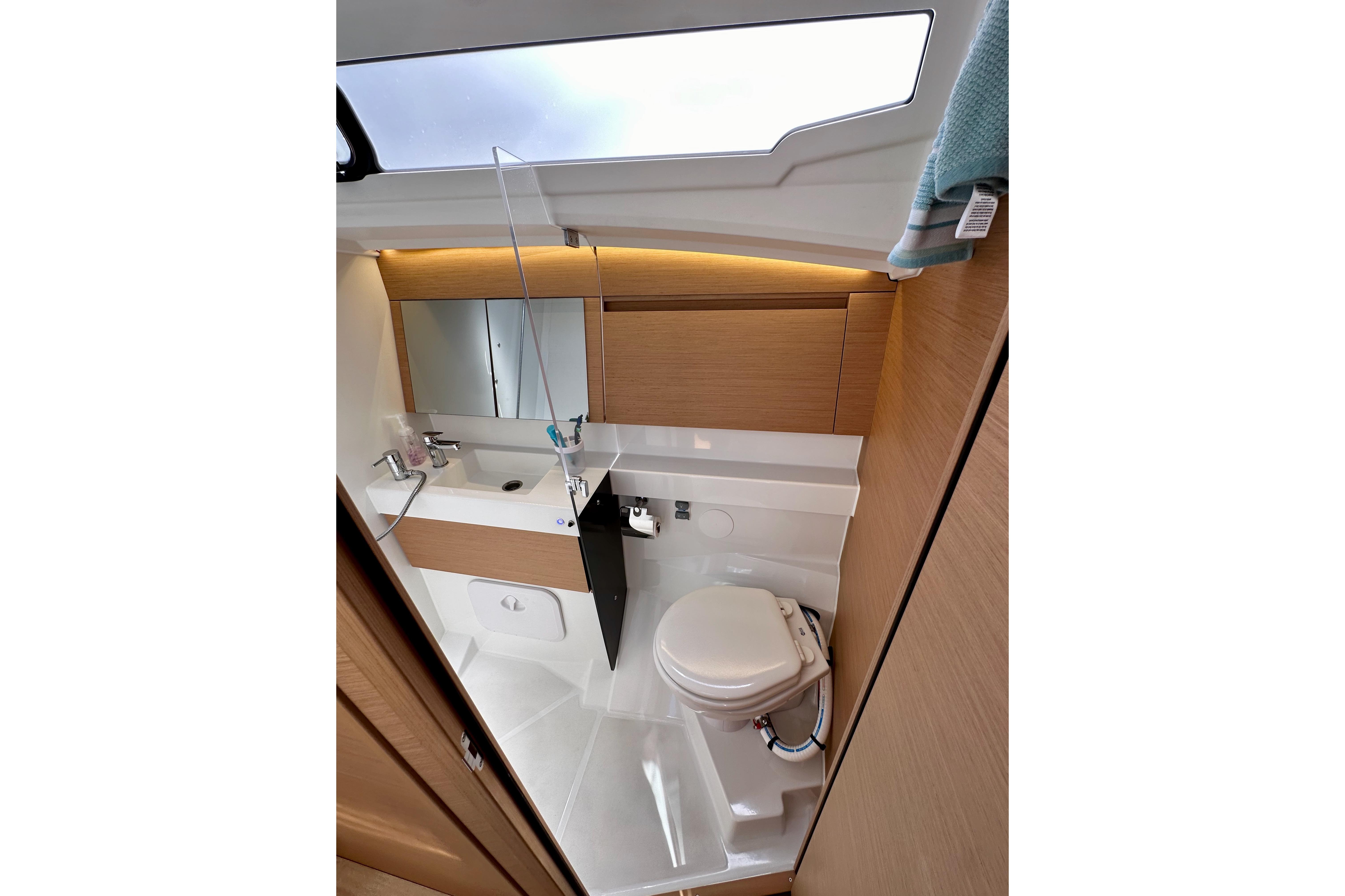 2024 Jeanneau Sun Odyssey 410 bathroom with modern fixtures and sleek design.