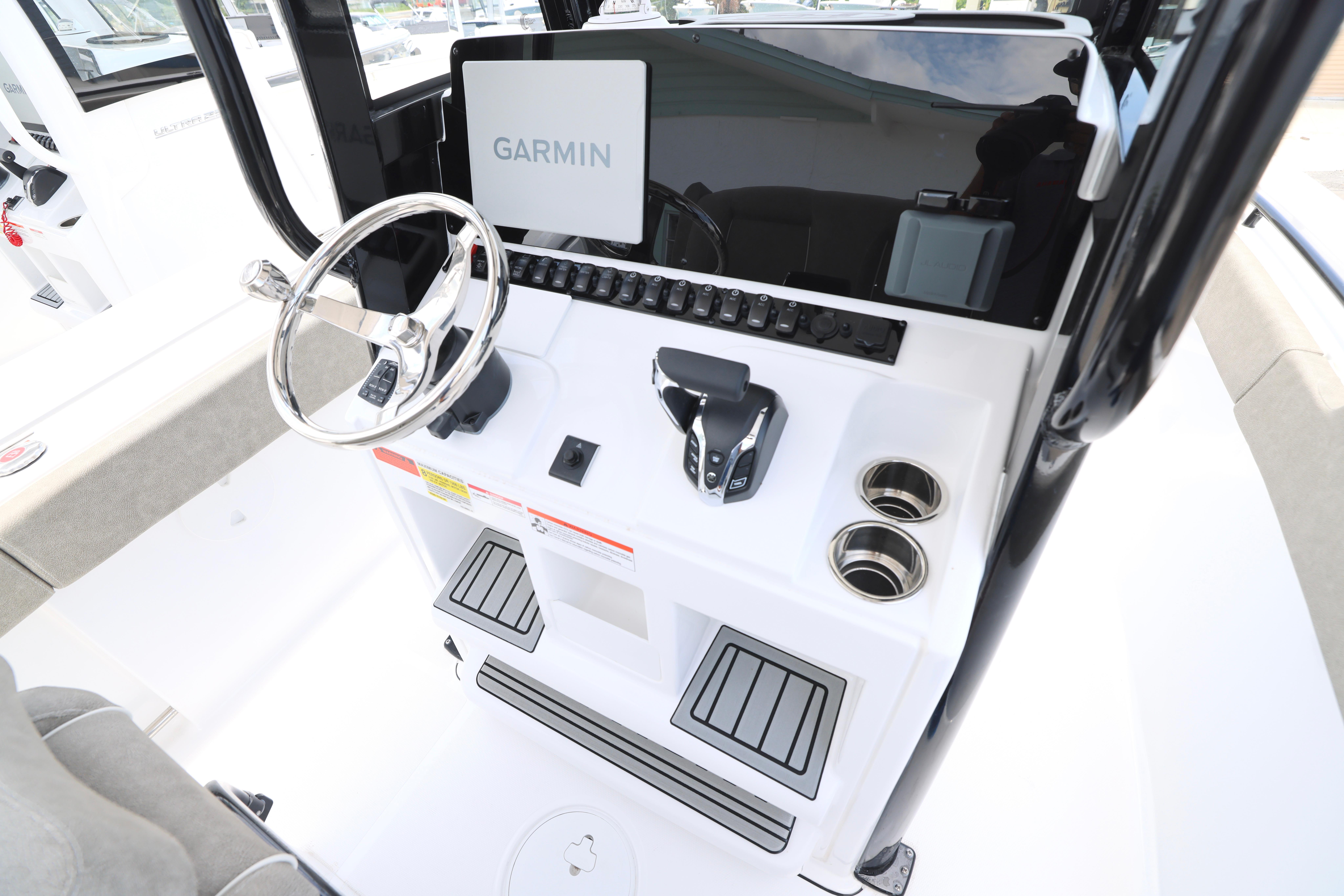 2026 Sea Hunt Ultra 245 SE boat console with Garmin display and steering wheel.