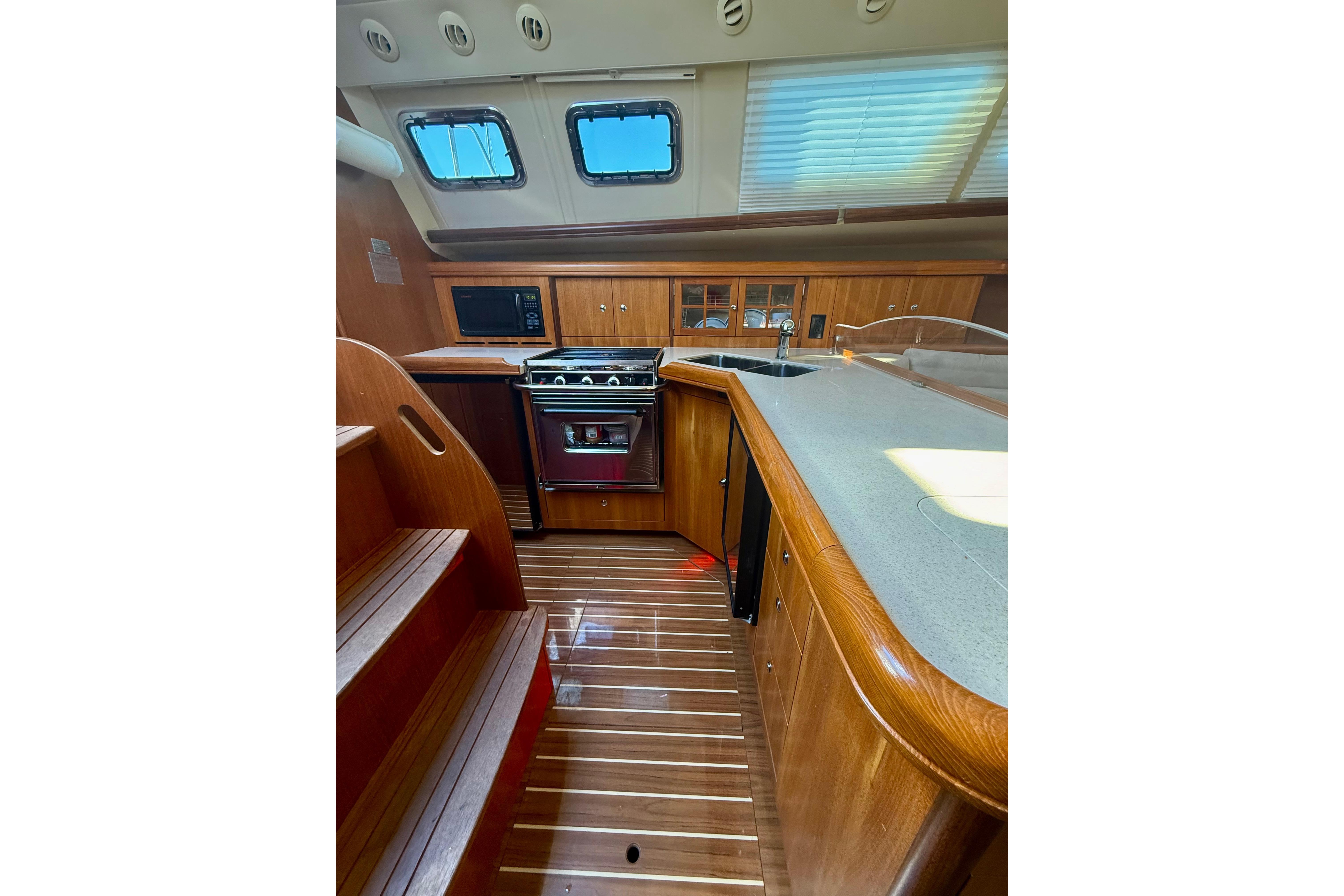 Luxurious 2007 Hunter 41 Deck Salon interior with wood finish and modern kitchen amenities.