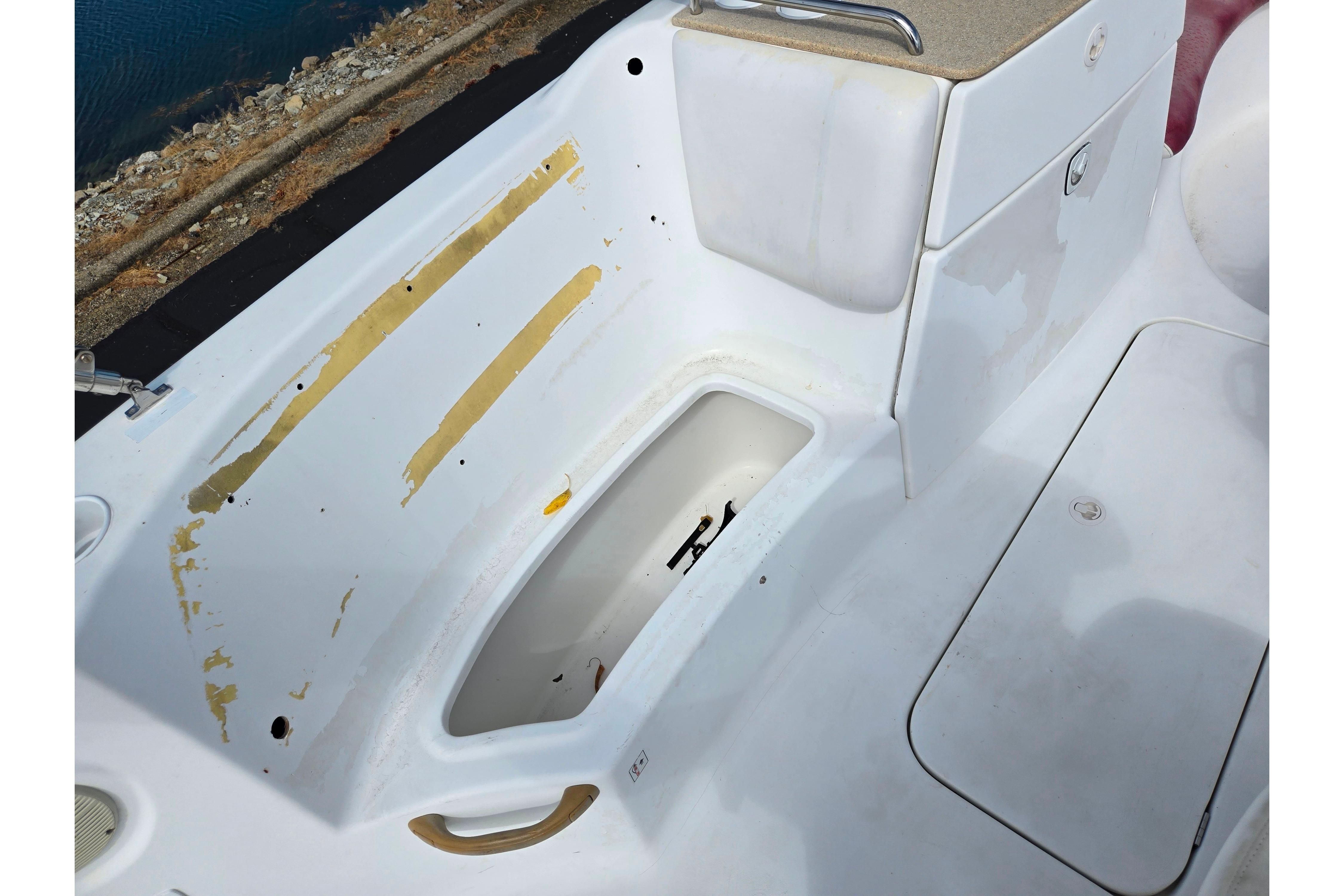 2004 Sea-Doo Islandia boat interior with storage compartment and peeling paint.