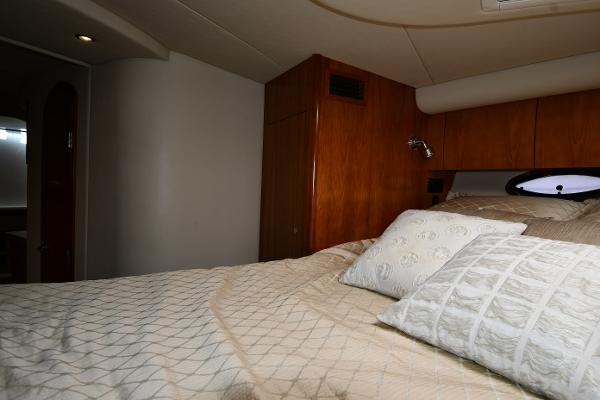 Interior cabin of 2010 Cruisers Yachts 390 Sports Coupe with cozy bedding.