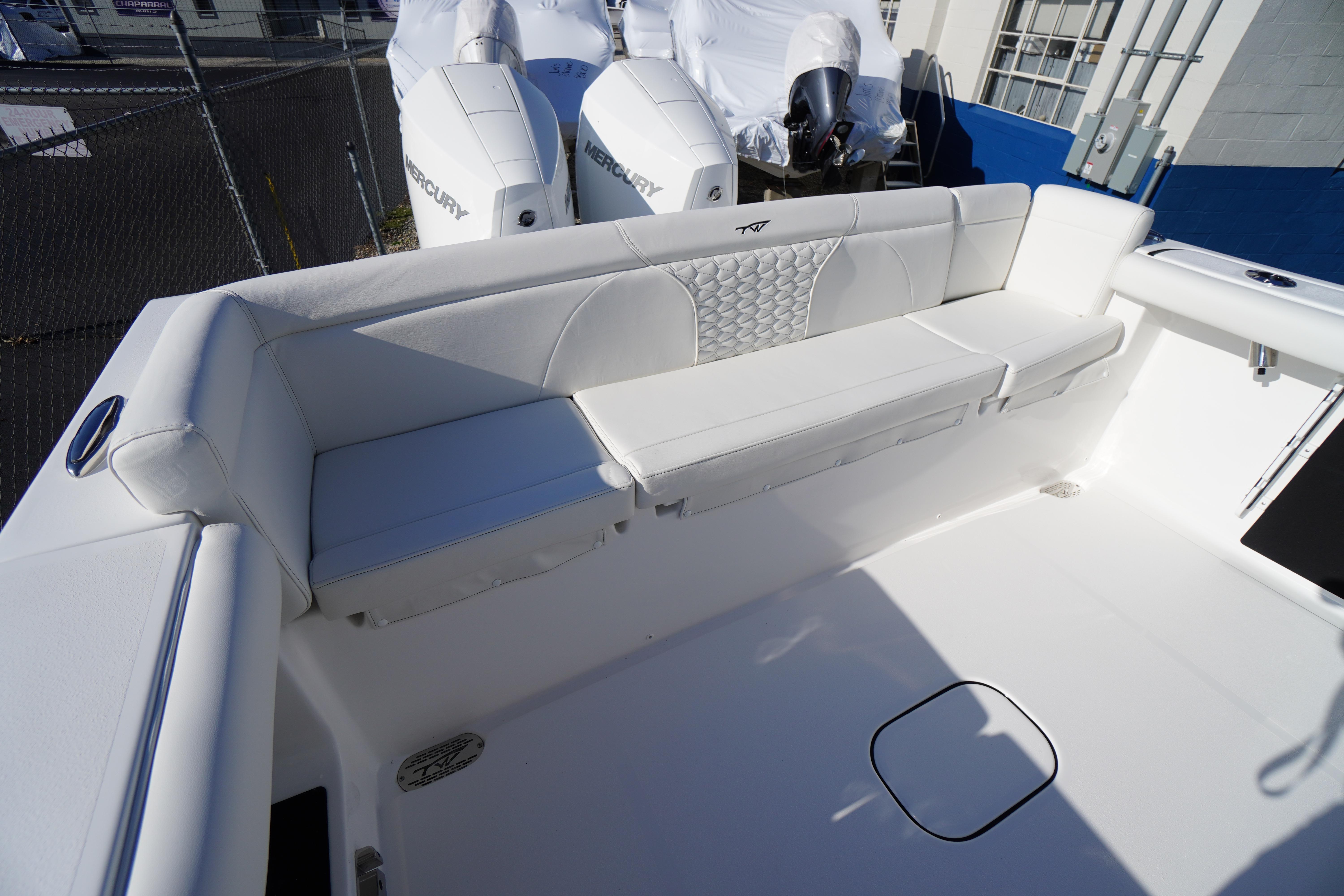 2026 Tidewater 272 LXF boat with white seating and dual Mercury engines.