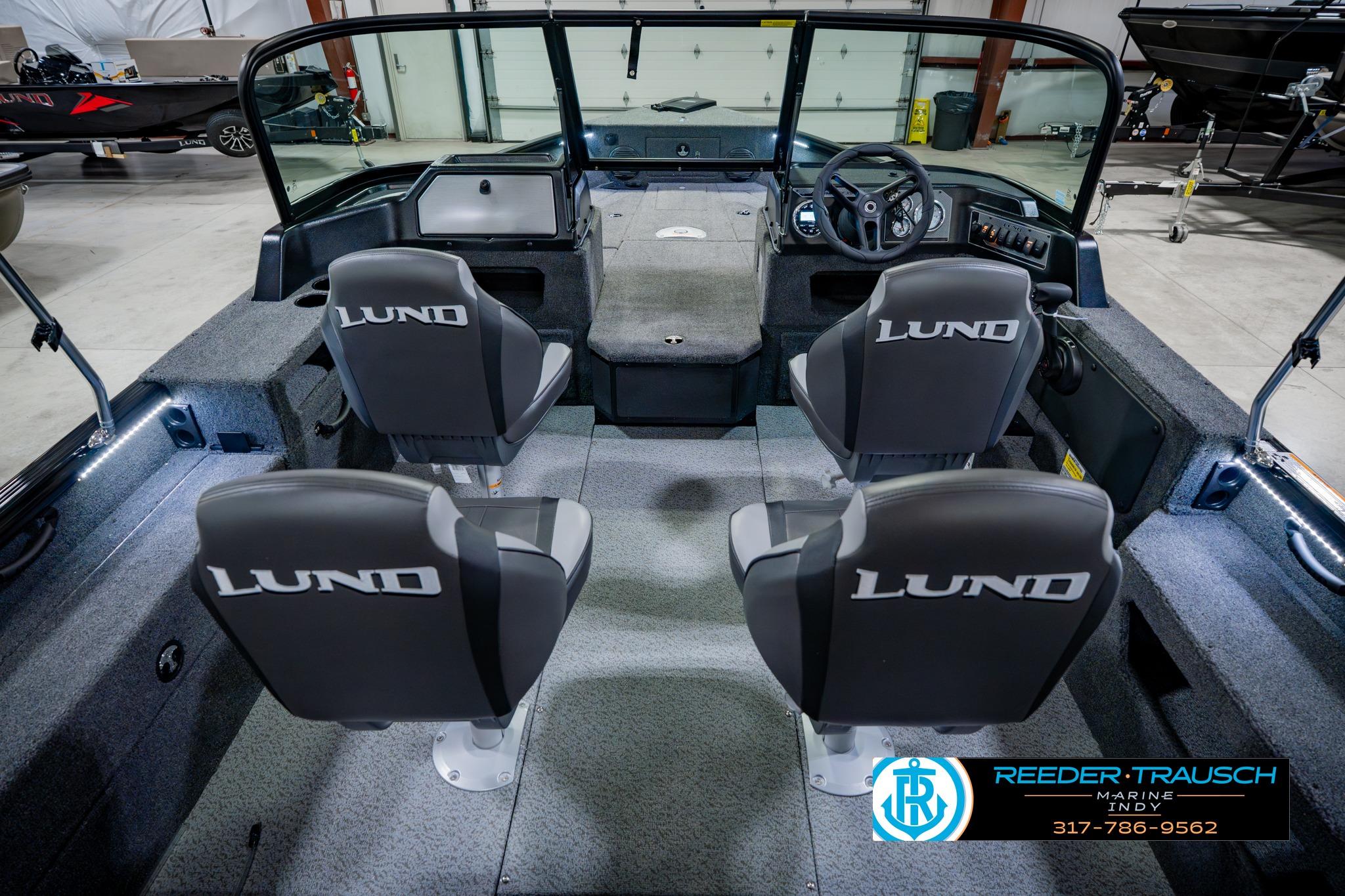 2026 Lund 1875 Impact XS boat interior with four seats in showroom.