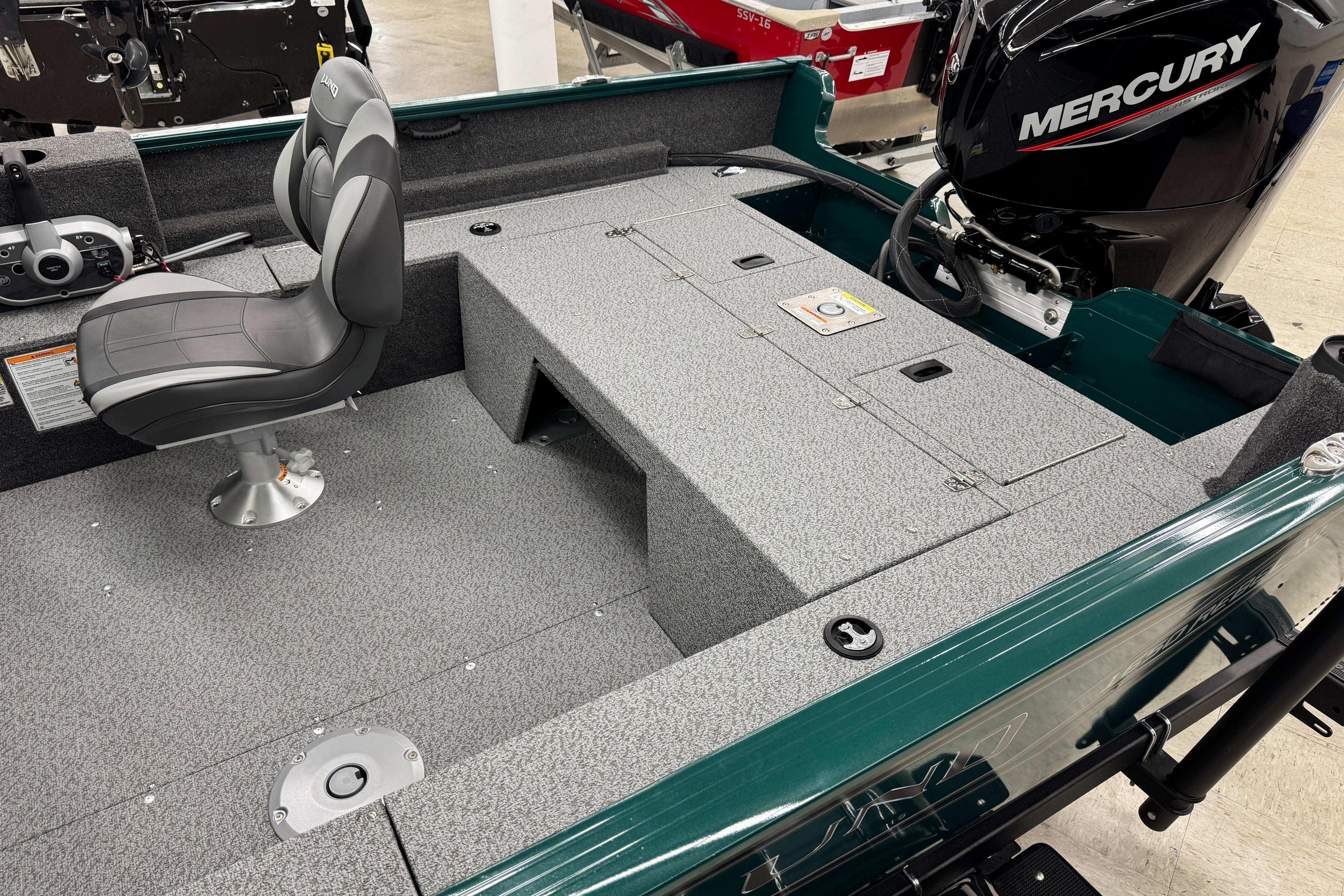 2026 Lund 1650 Rebel XL Sport boat interior with Mercury engine and seating.