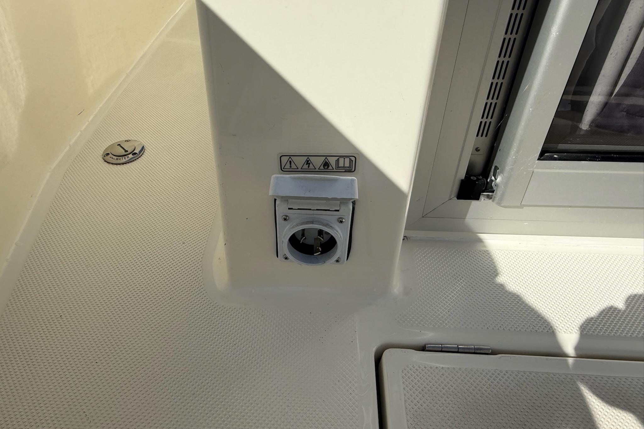 2024 Bayliner Trophy T25 Pilothouse deck with utility outlet and hatch.