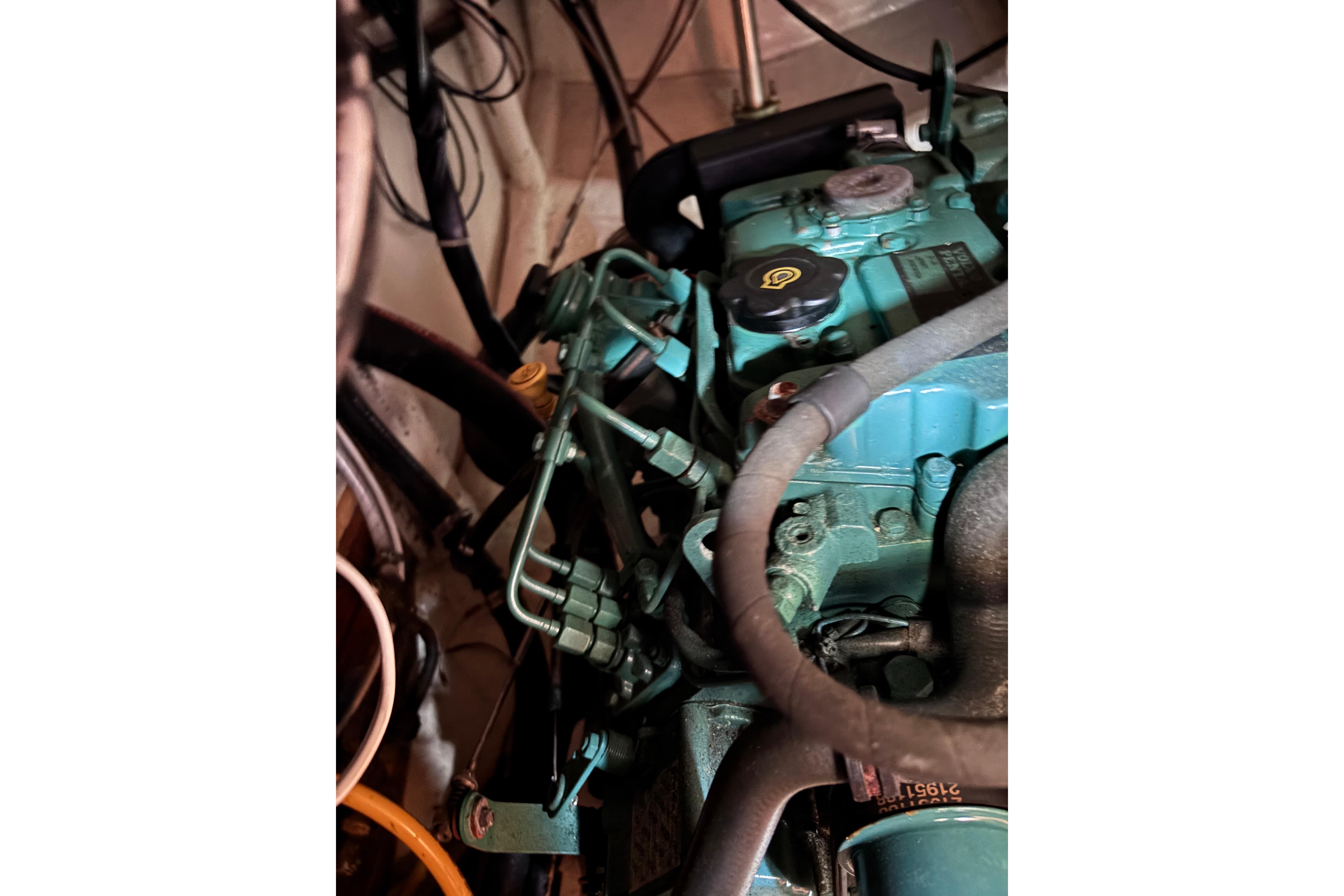 Close-up of a 1978 Swift 33 engine with visible hoses and components.
