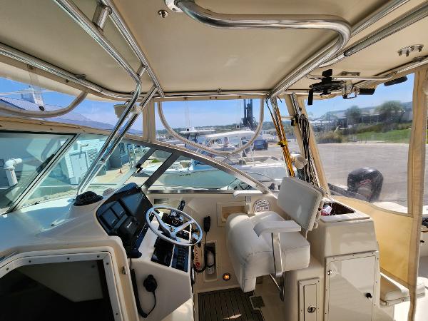 2005 Pursuit 3070 Offshore Center Console interior with helm, seating, and controls.