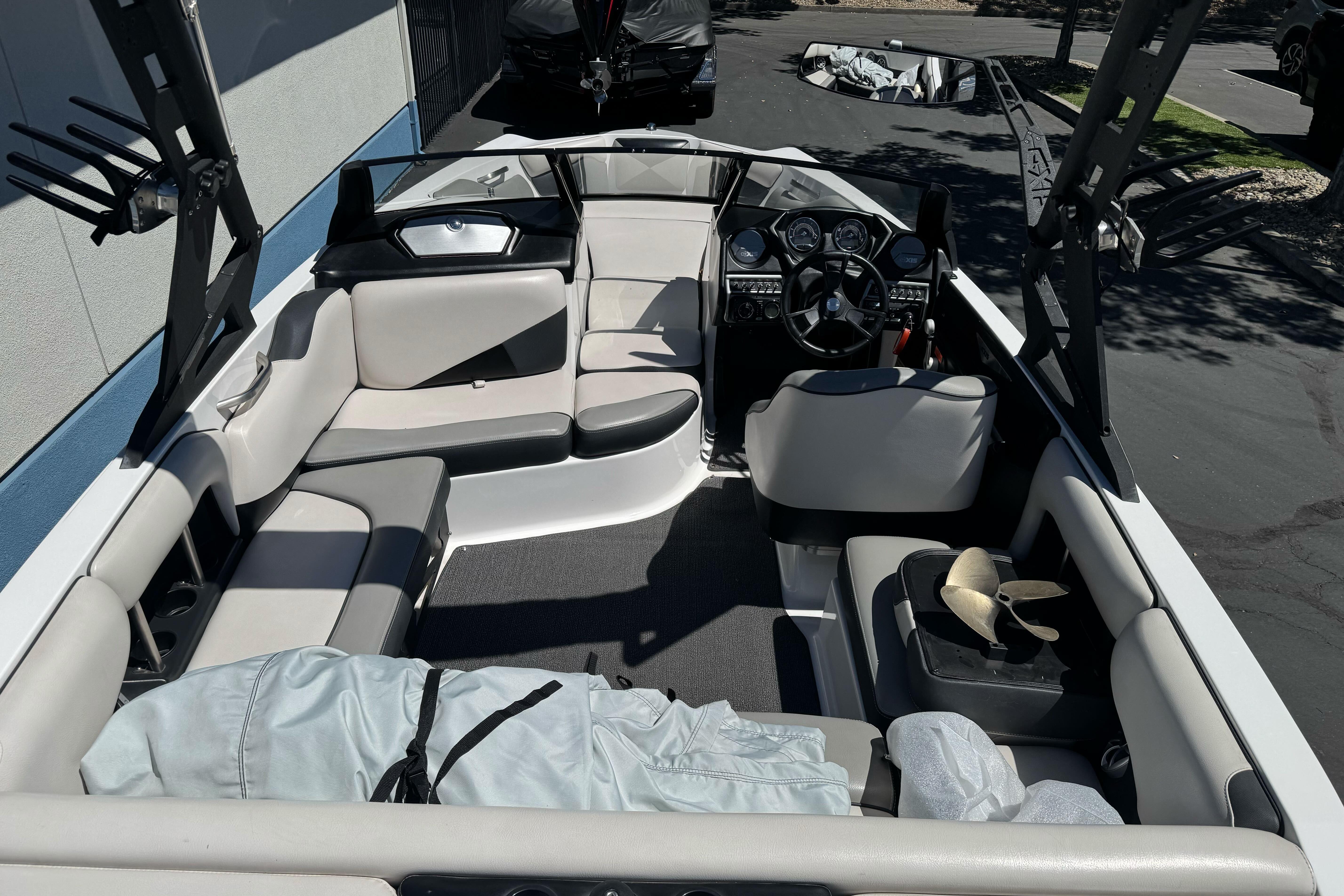 2015 Axis A20 boat interior with seating, steering wheel, and storage compartments.