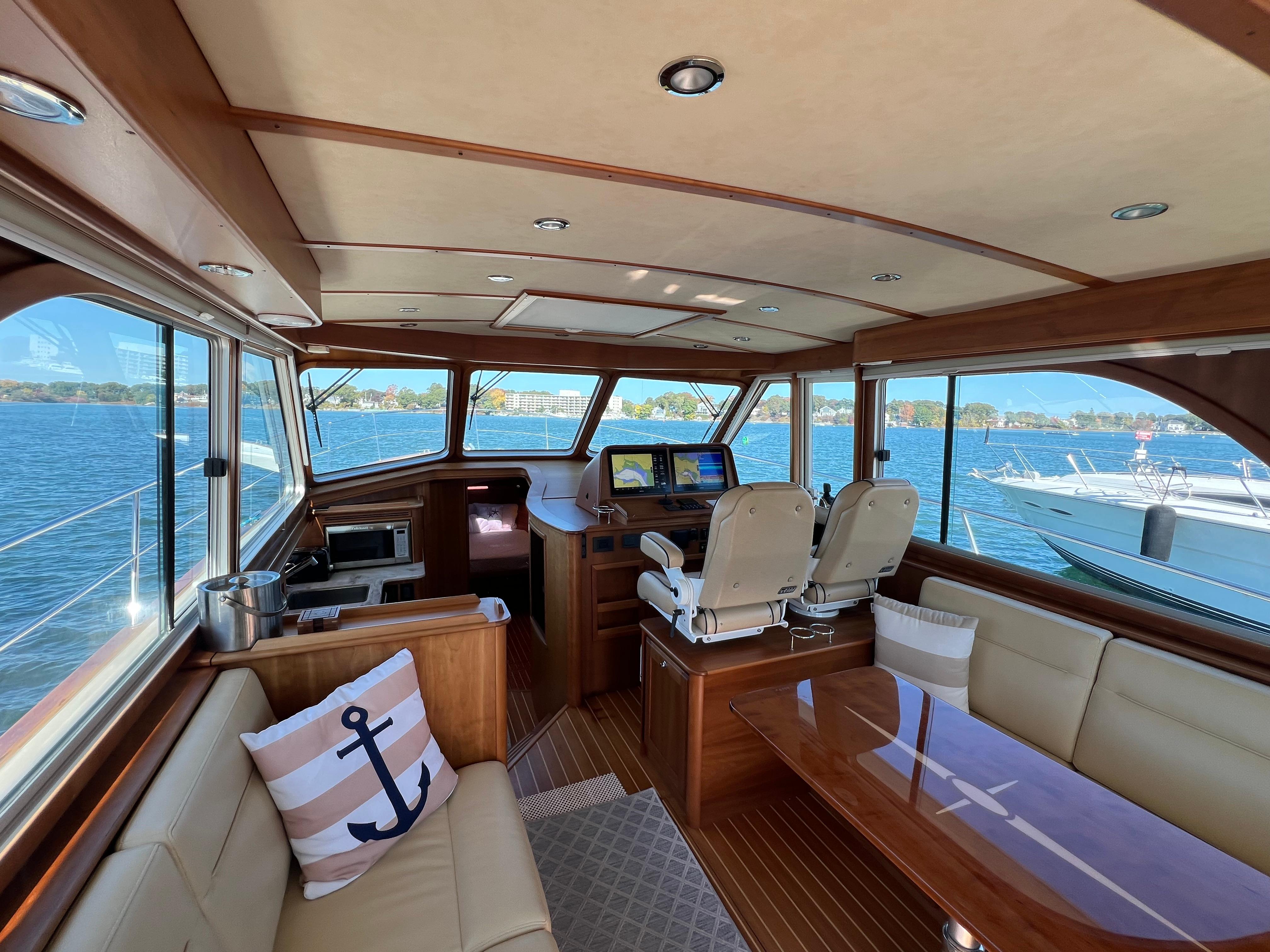 Luxurious 2018 Sabre 45 Salon Express yacht interior with panoramic windows and elegant seating.