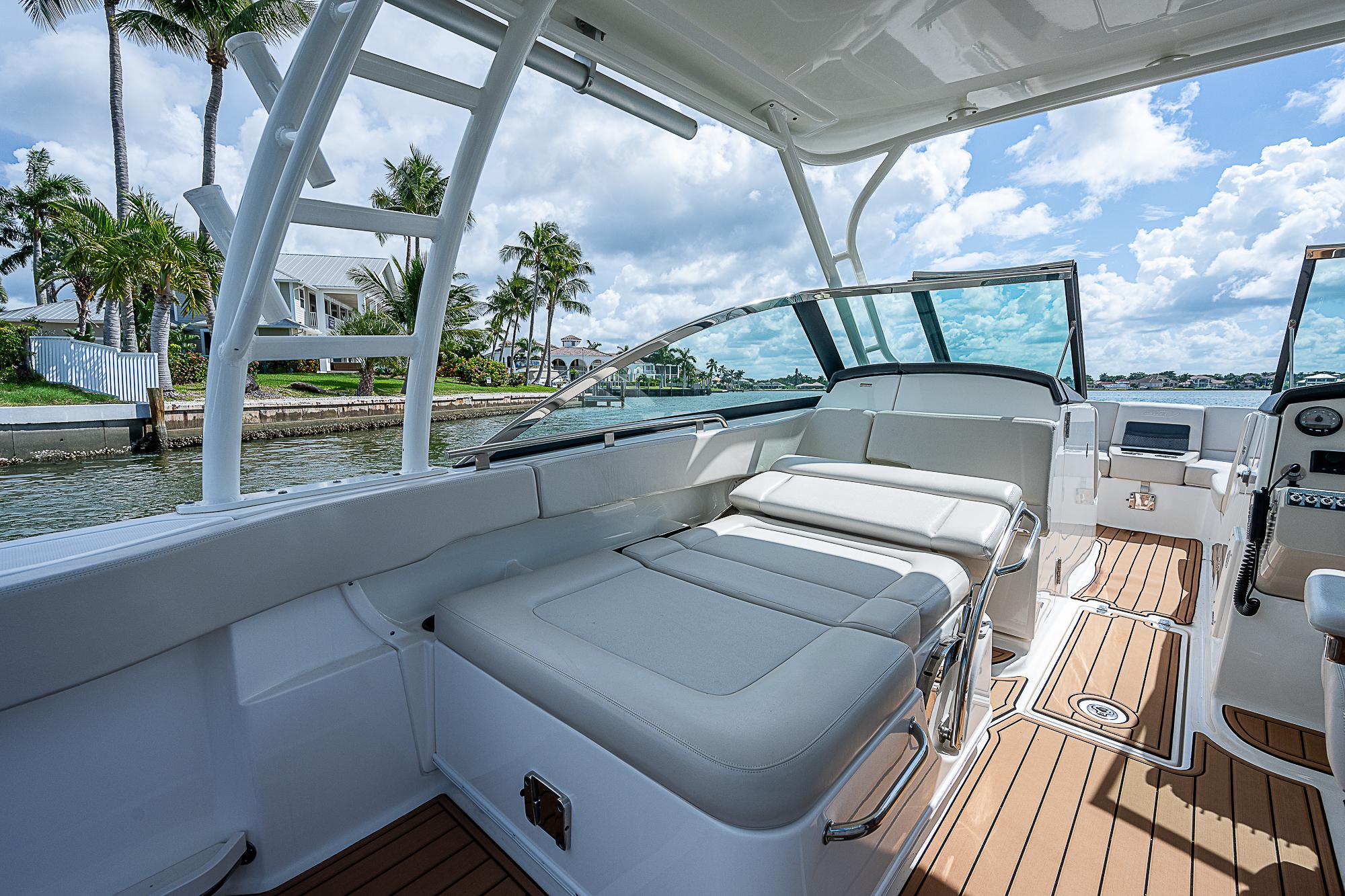 2018 Boston Whaler 270 Vantage boat interior with luxurious seating and scenic waterfront view.