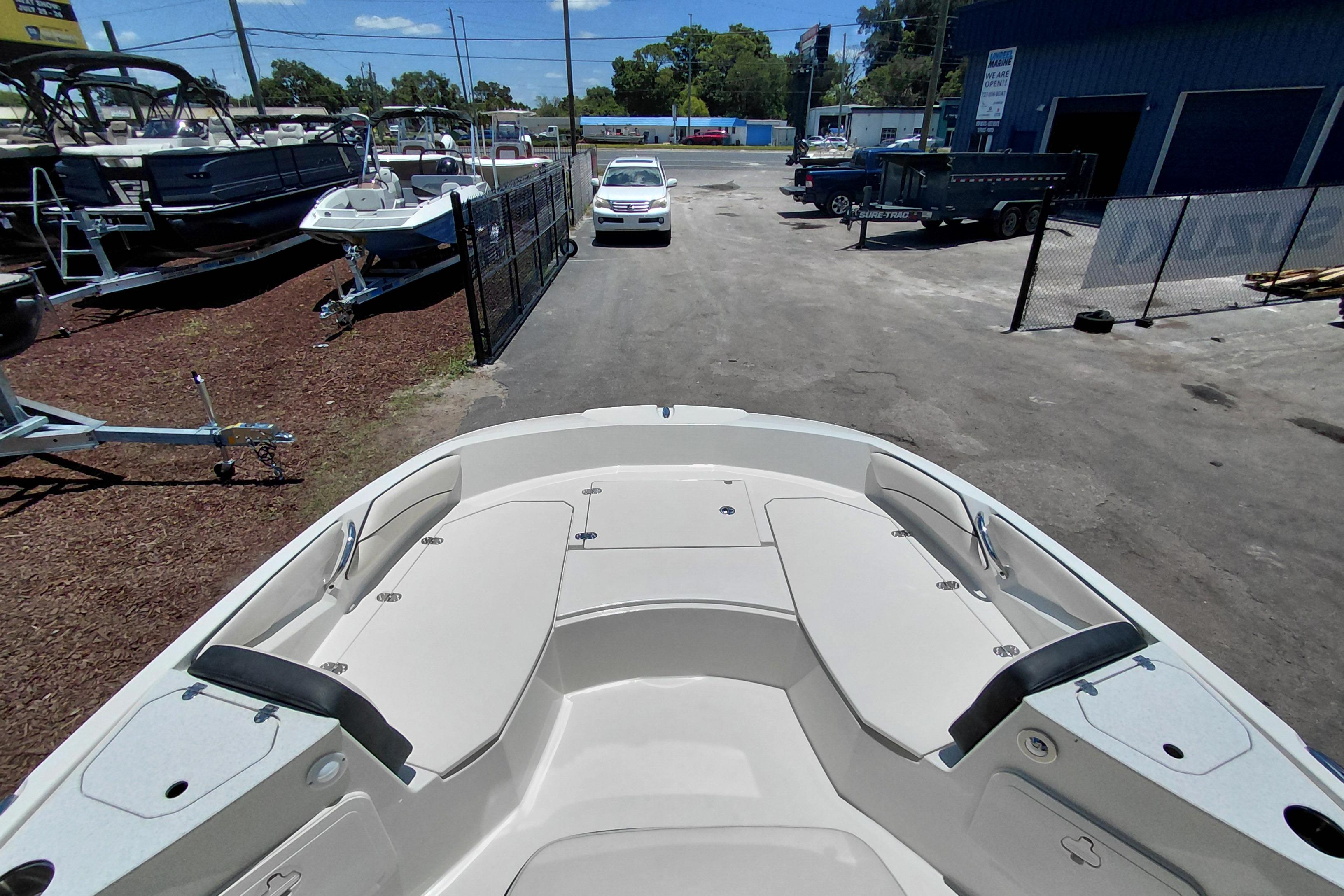 2023 Stingray 206 CC boat at dealership, showcasing spacious seating and sleek design.
