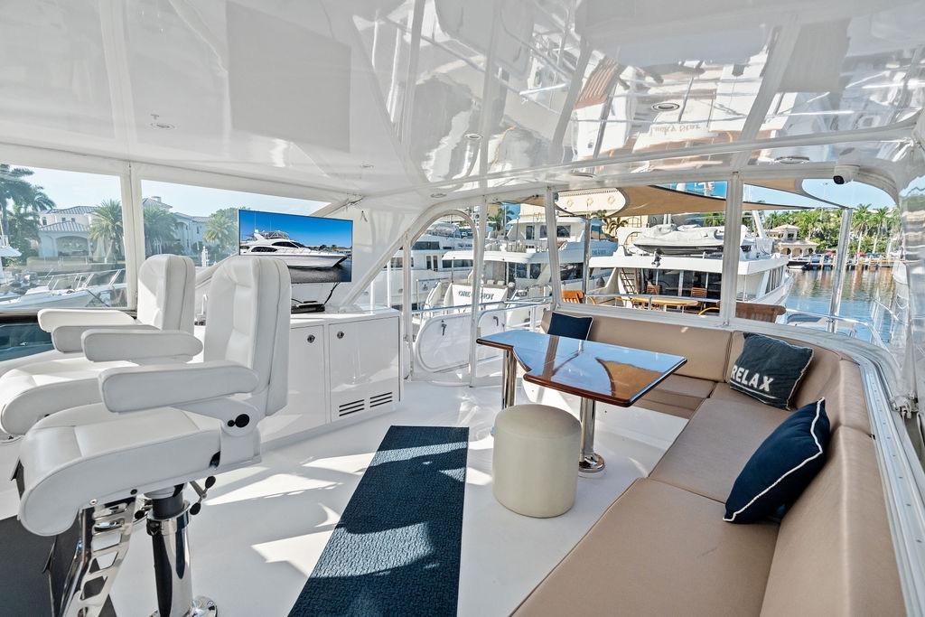 Luxurious interior of 2008 Hatteras 64 Motor Yacht with seating and helm chairs.