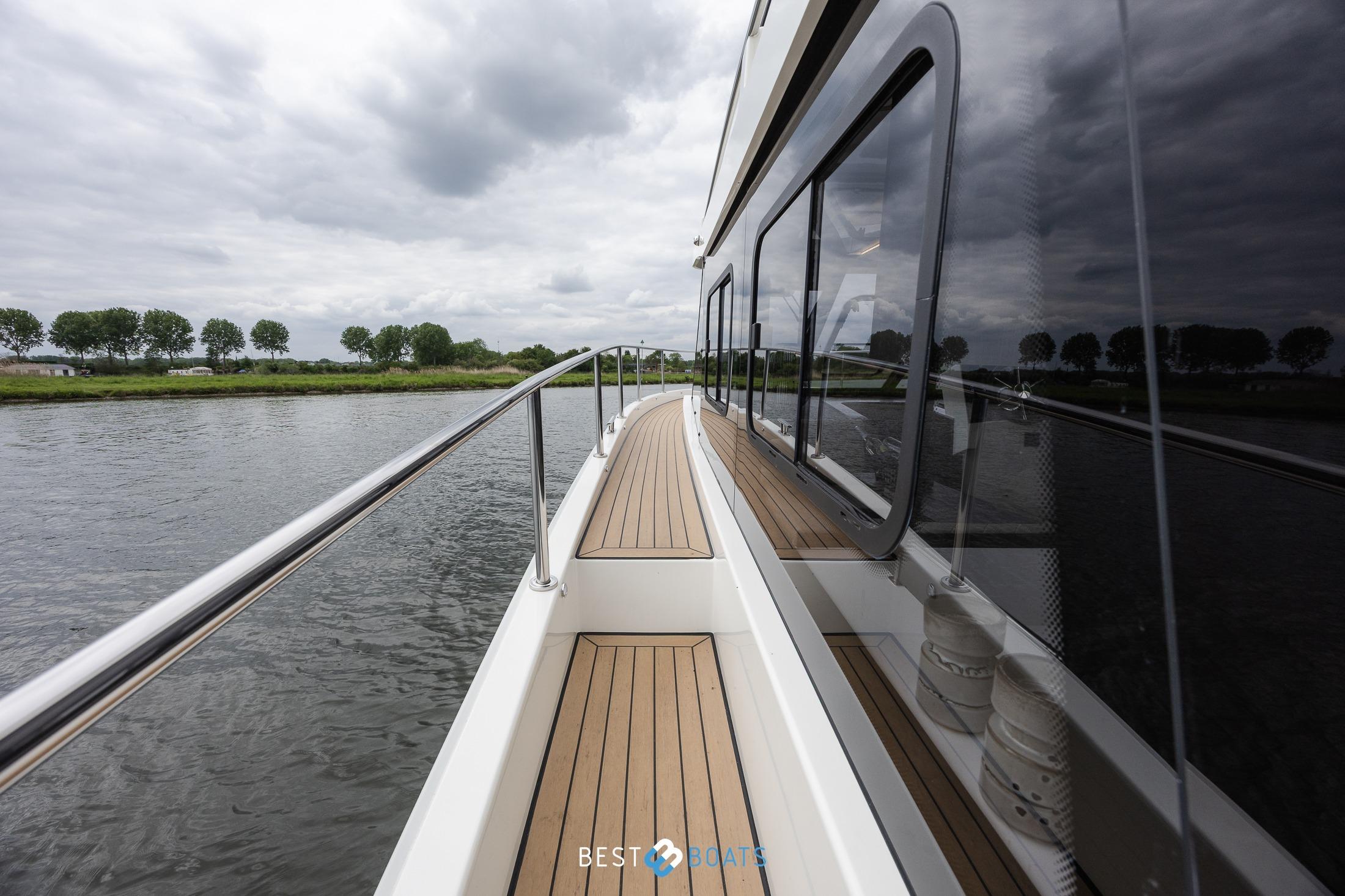 2023 Cobra Yachts Futura 36 Premium Fly on a serene river, showcasing sleek design.