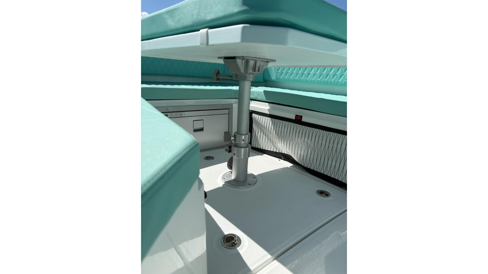 2025 De Antonio Yachts e23 open interior with teal seating and sleek design.