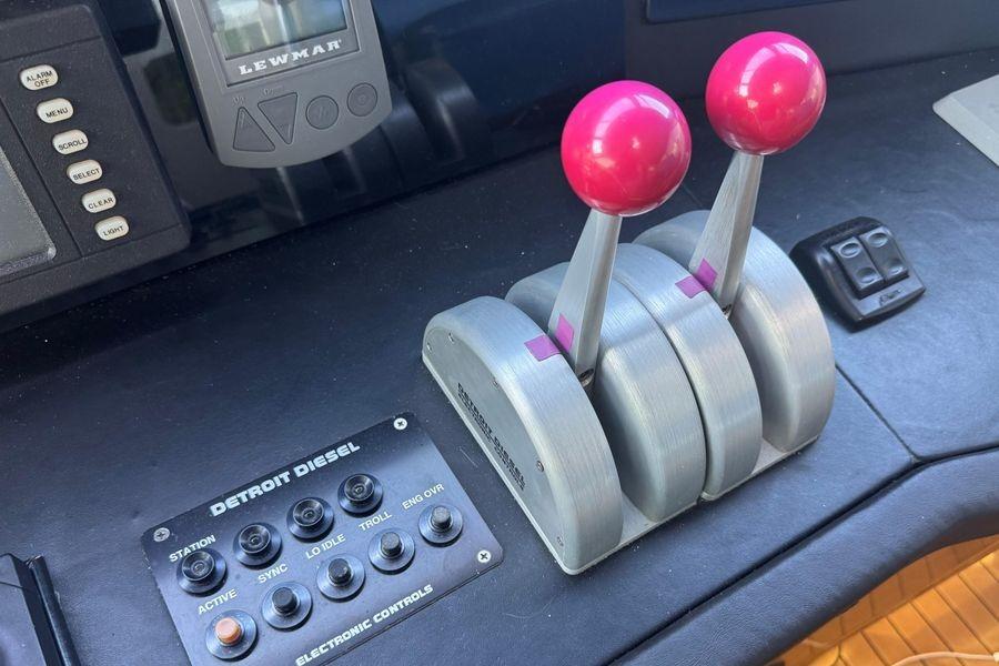 Control panel of a 2002 Viking 61 Enclosed Bridge yacht with throttle levers.