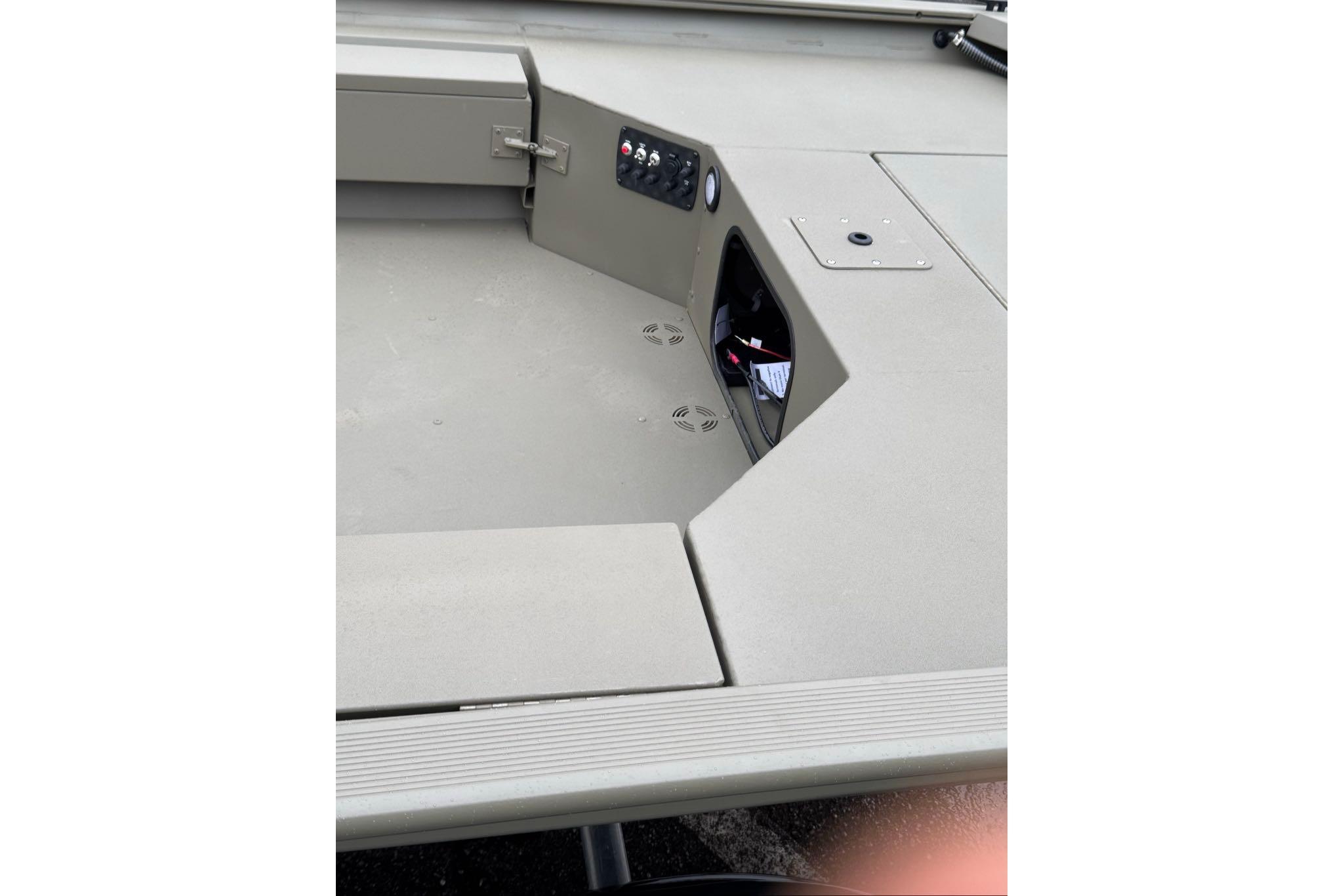 2026 Tracker Grizzly 1654 T Sportsman boat interior with control panel and storage compartment.