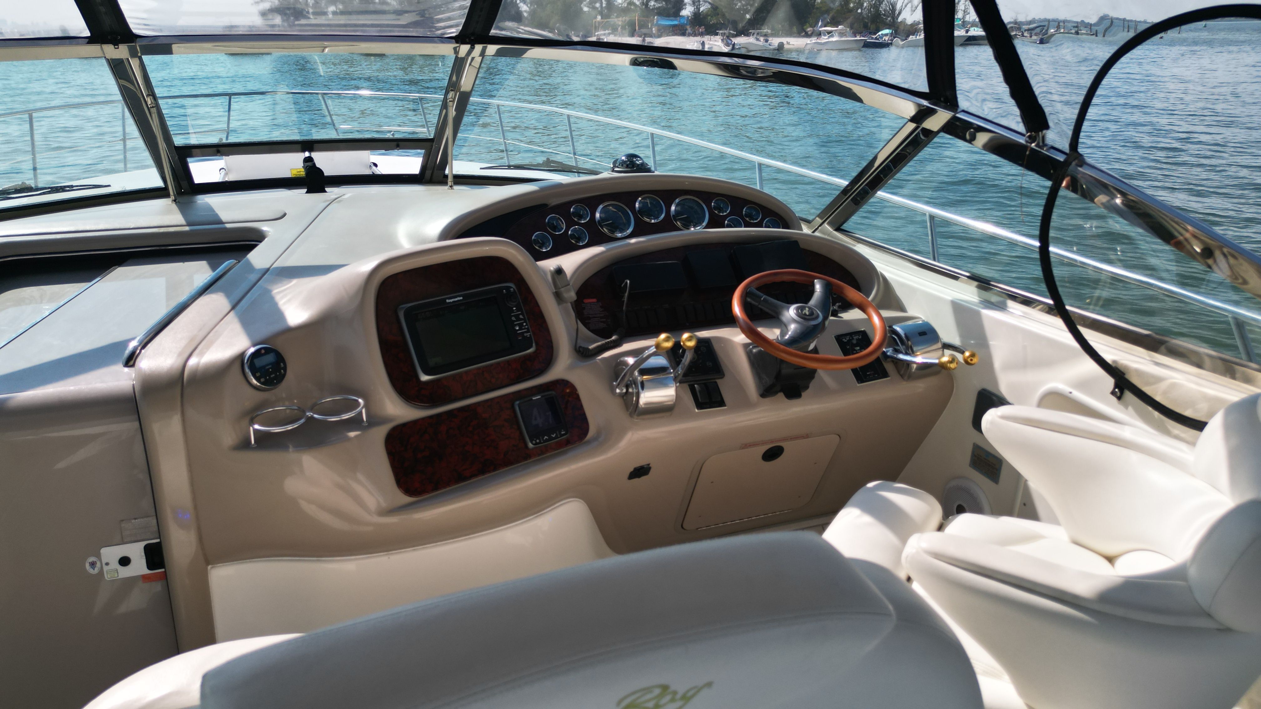 The cockpit of a 1999 Sea Ray 380 Sundancer with sleek controls.