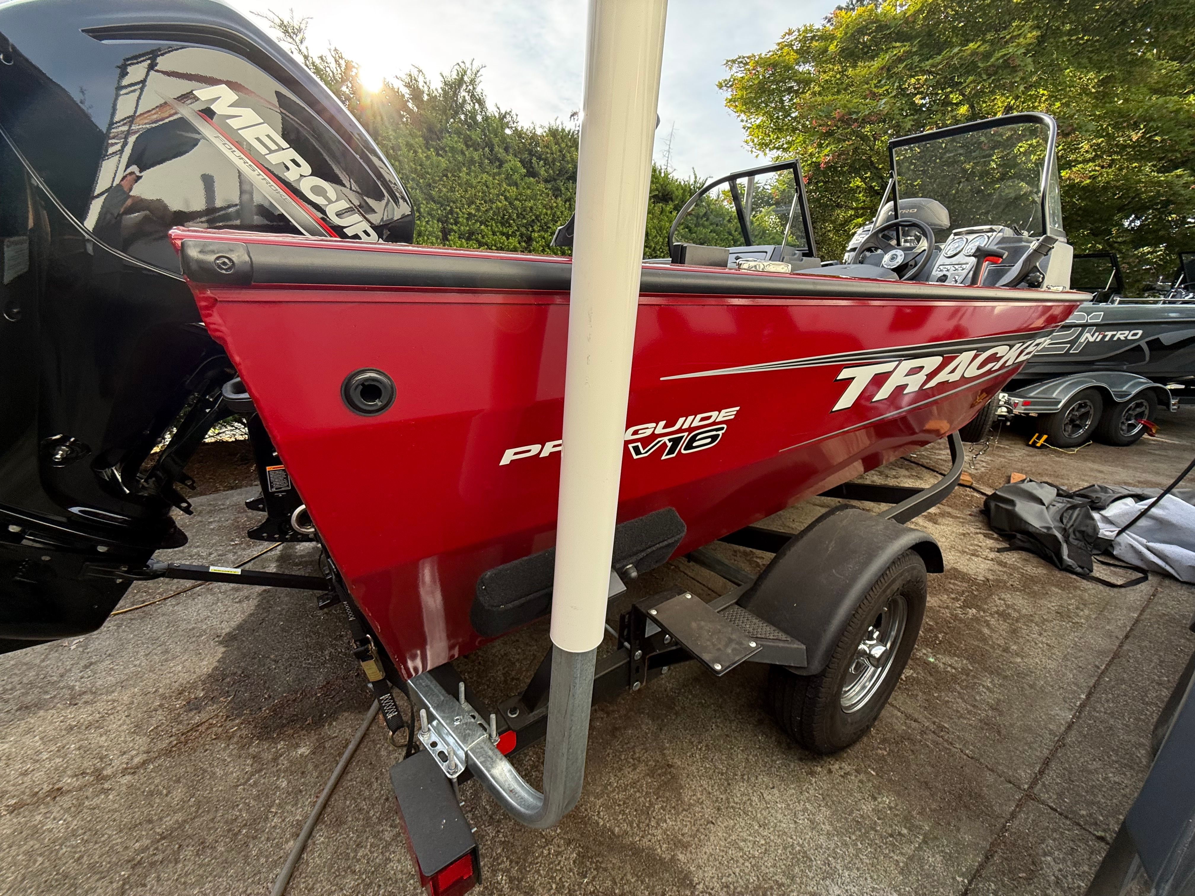 Red 2025 Tracker Pro Guide V-16 WT boat on trailer.