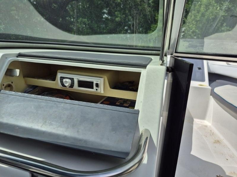 The image shows the dashboard of a 1996 Cobalt 220 boat with a radio.