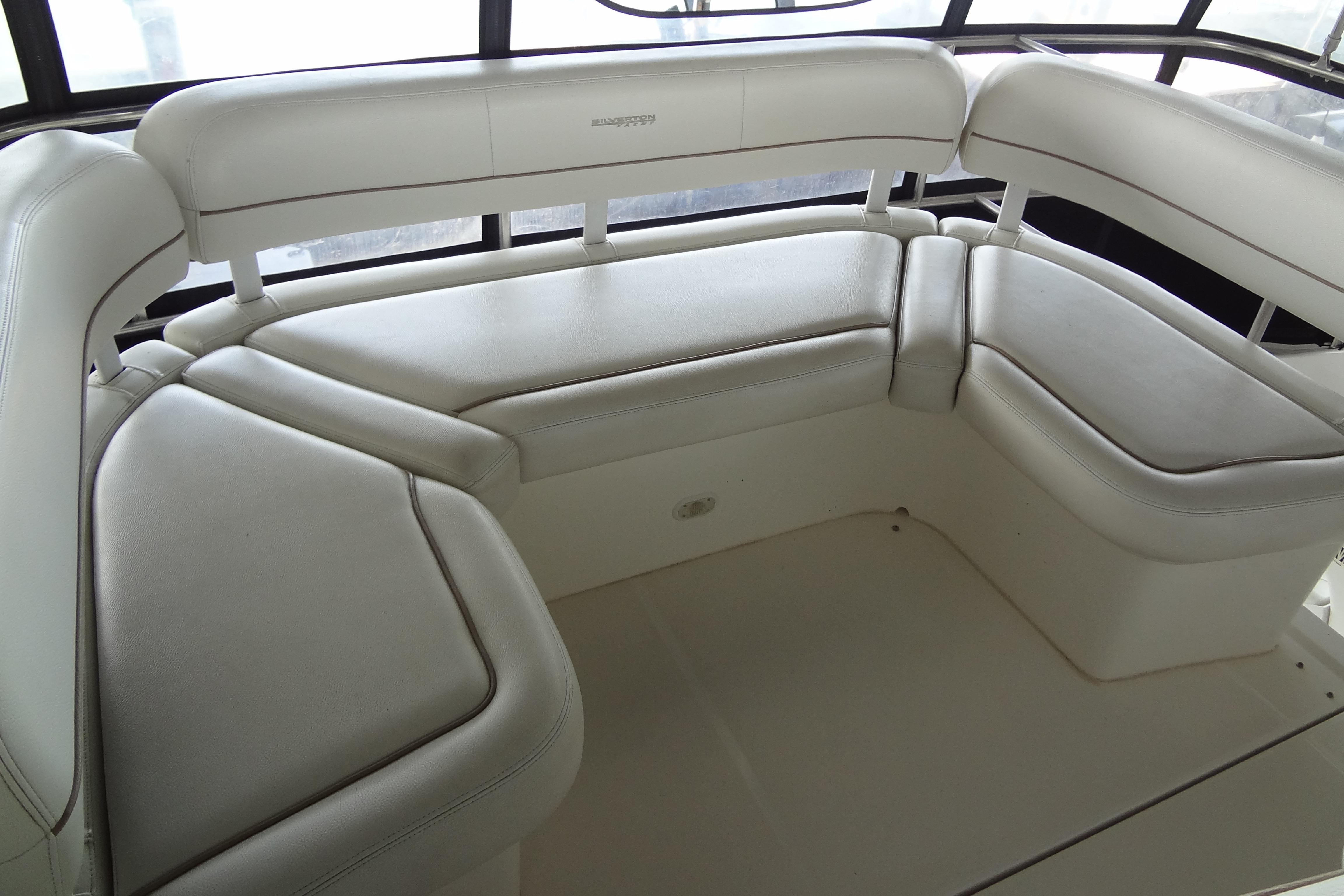 2005 Silverton 34 Convertible yacht interior with white cushioned seating.