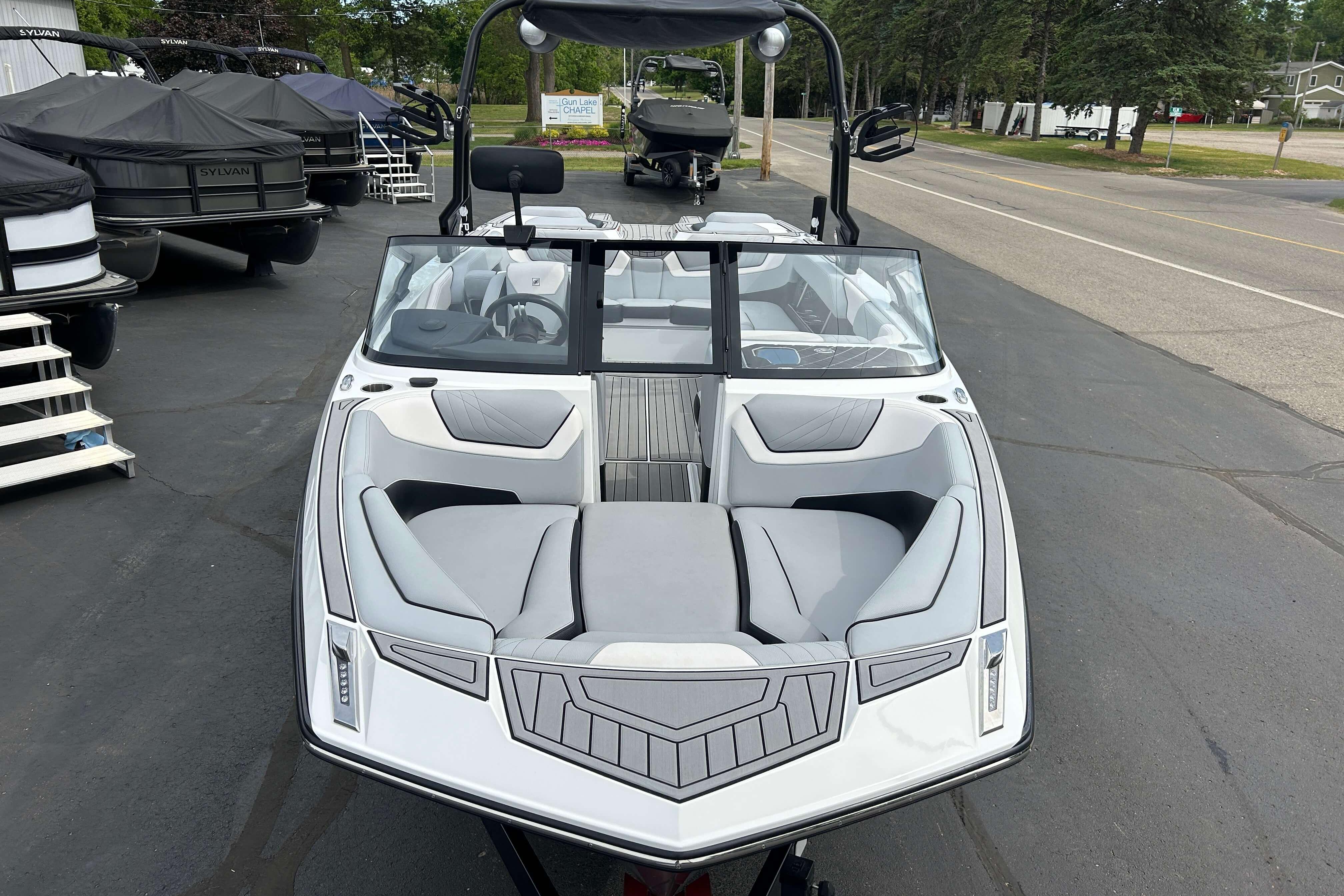 2021 Nautique Super Air Nautique GS24 boat with sleek design, parked outdoors.
