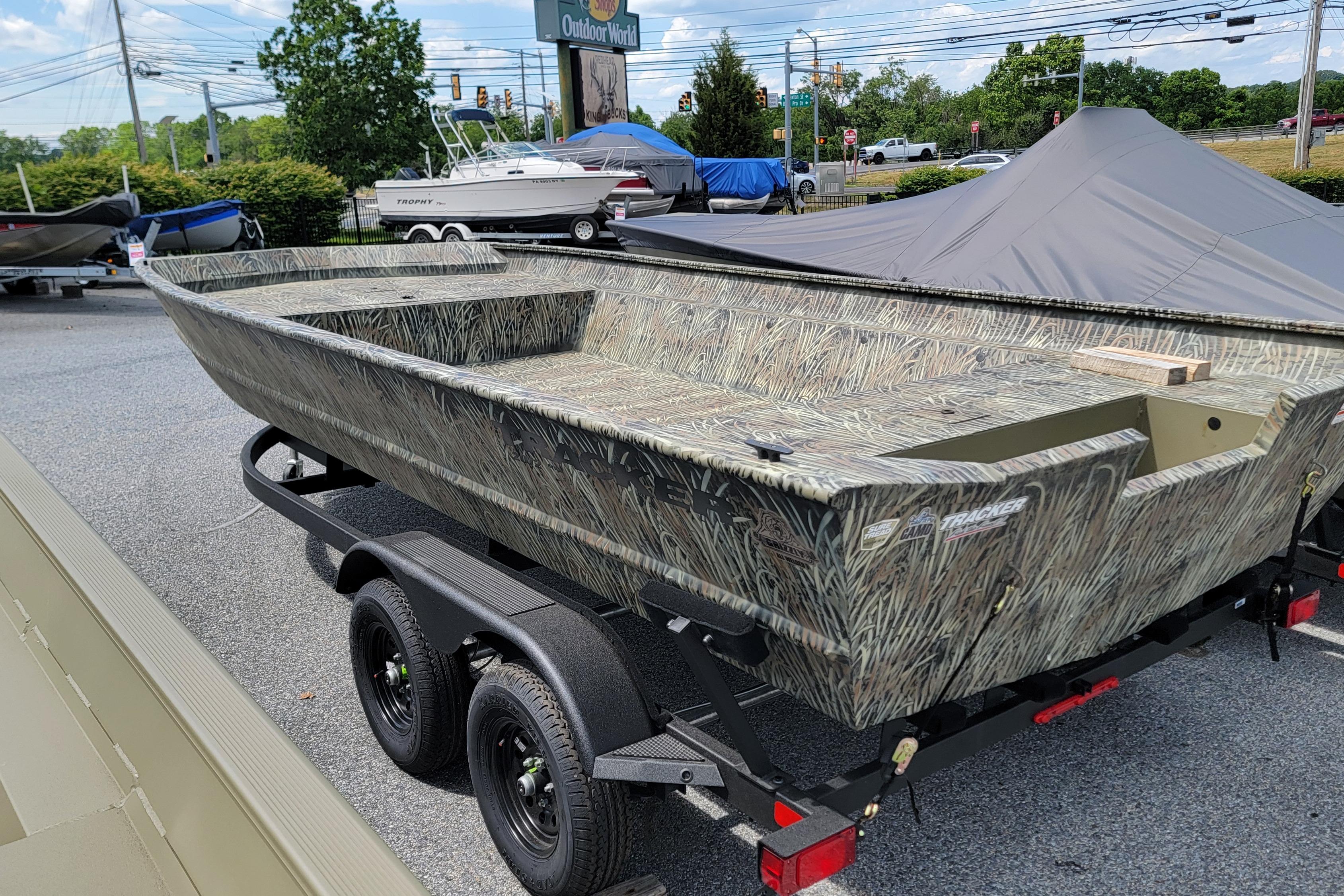 2026 Tracker Grizzly 2072 Utility boat on trailer, camo design, outdoor display.