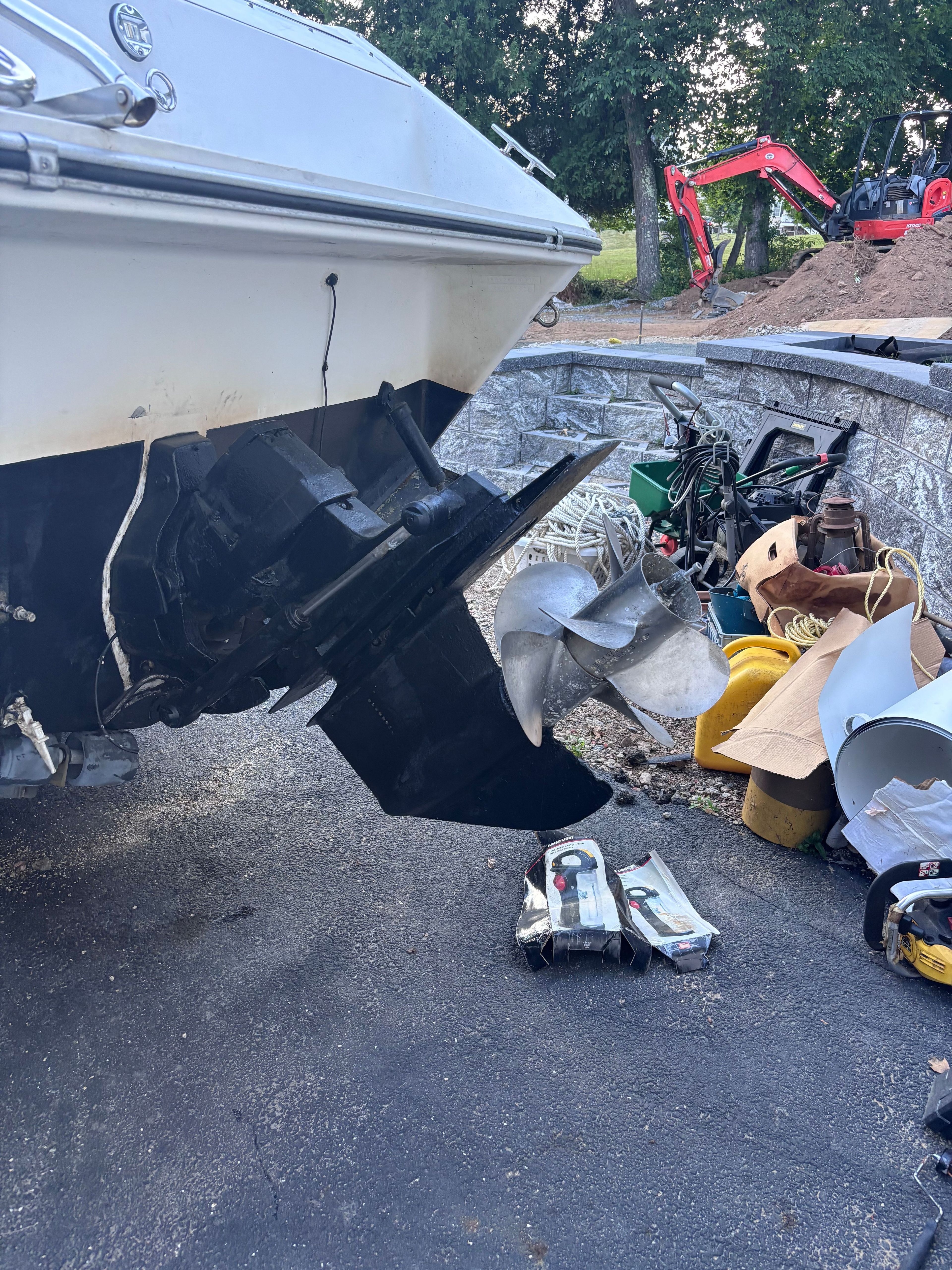 A 1989 Sea Ray Sundancer with visible drive and propeller, surrounded by equipment.