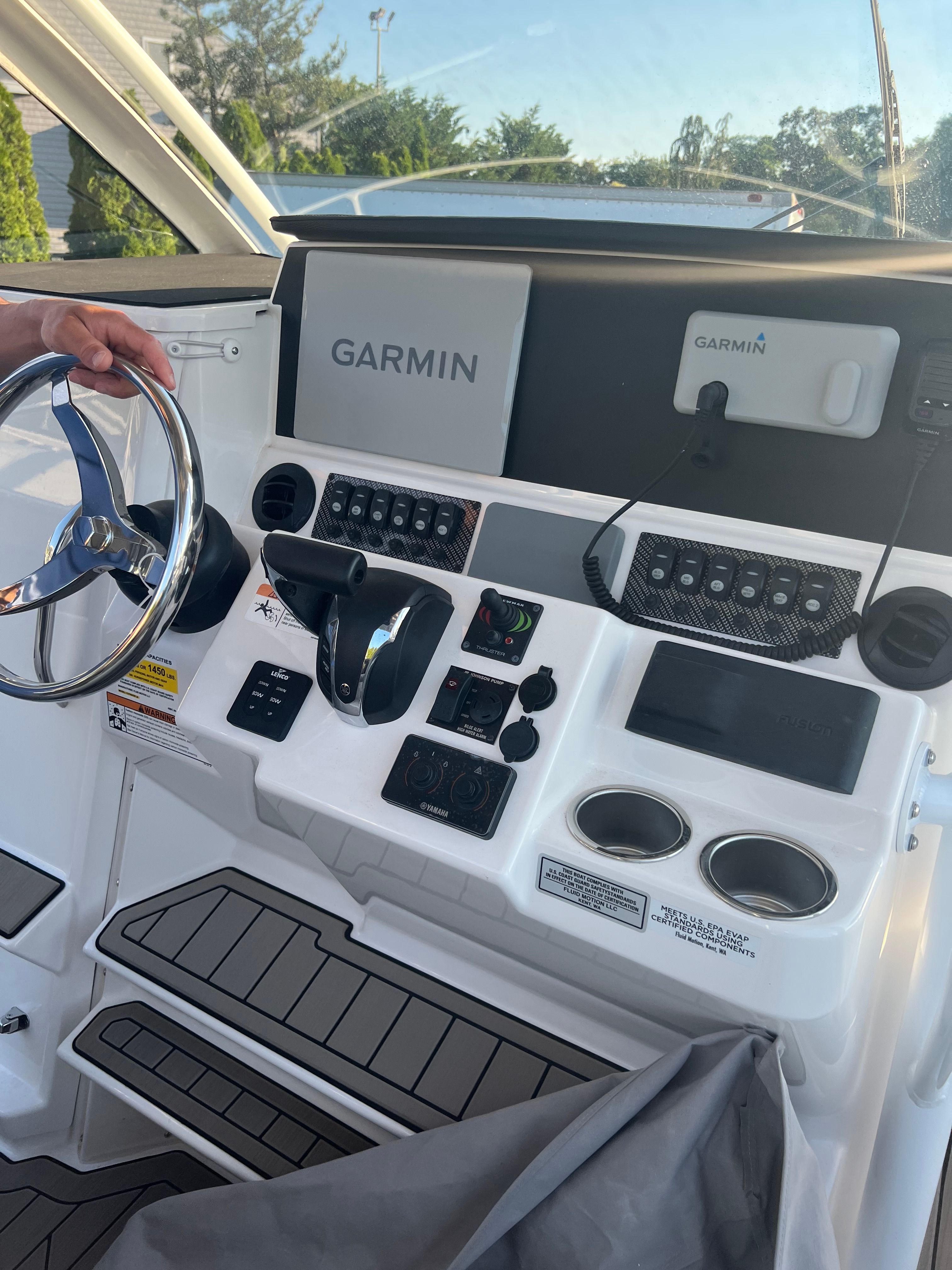 The cockpit of a 2022 Cutwater C-24 CW with Garmin navigation system and control console.