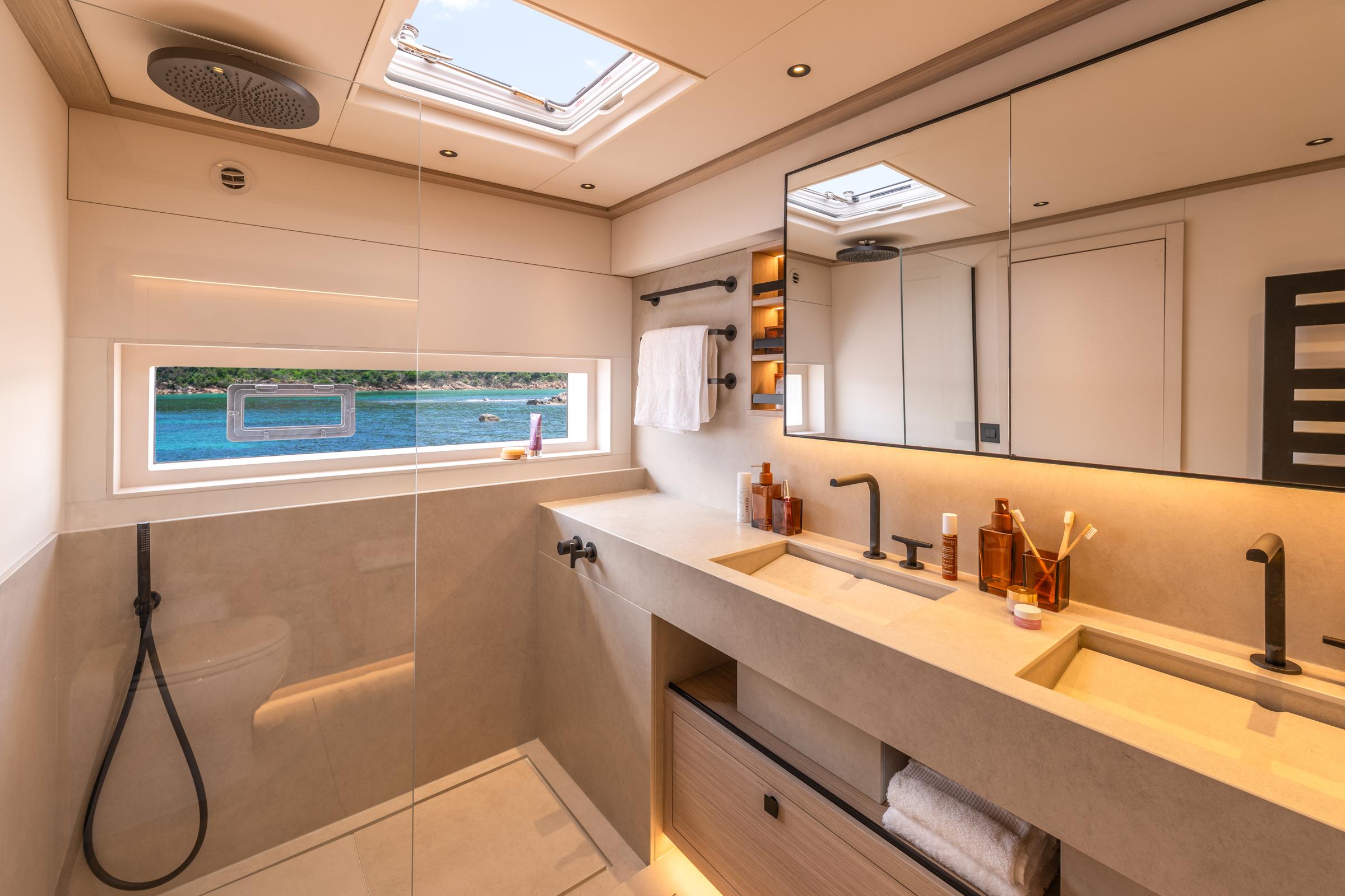 Luxurious bathroom in 2025 Lagoon Eighty 2 yacht with modern fixtures and ocean view.