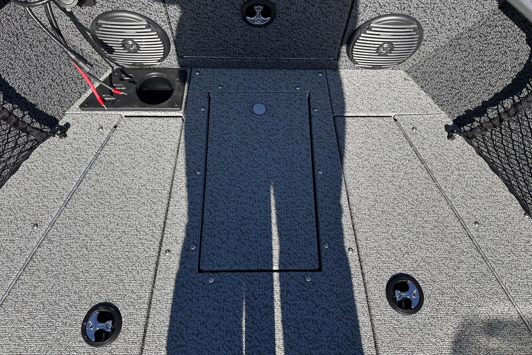 2026 Lund 1875 Impact XS SS boat interior with storage compartments and speakers.