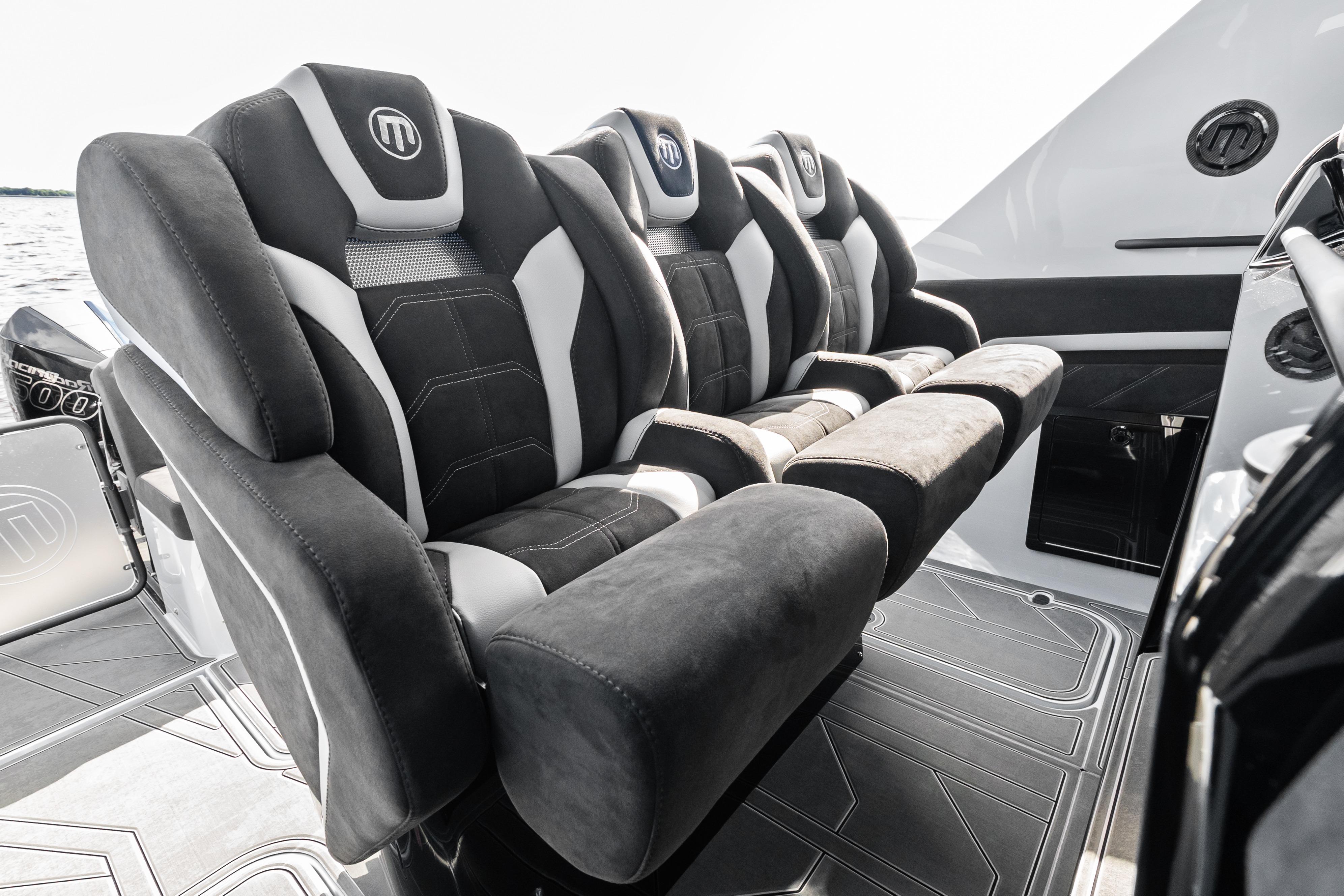 Luxurious seating on 2027 Mystic Powerboats M4200, featuring plush black and white upholstery.