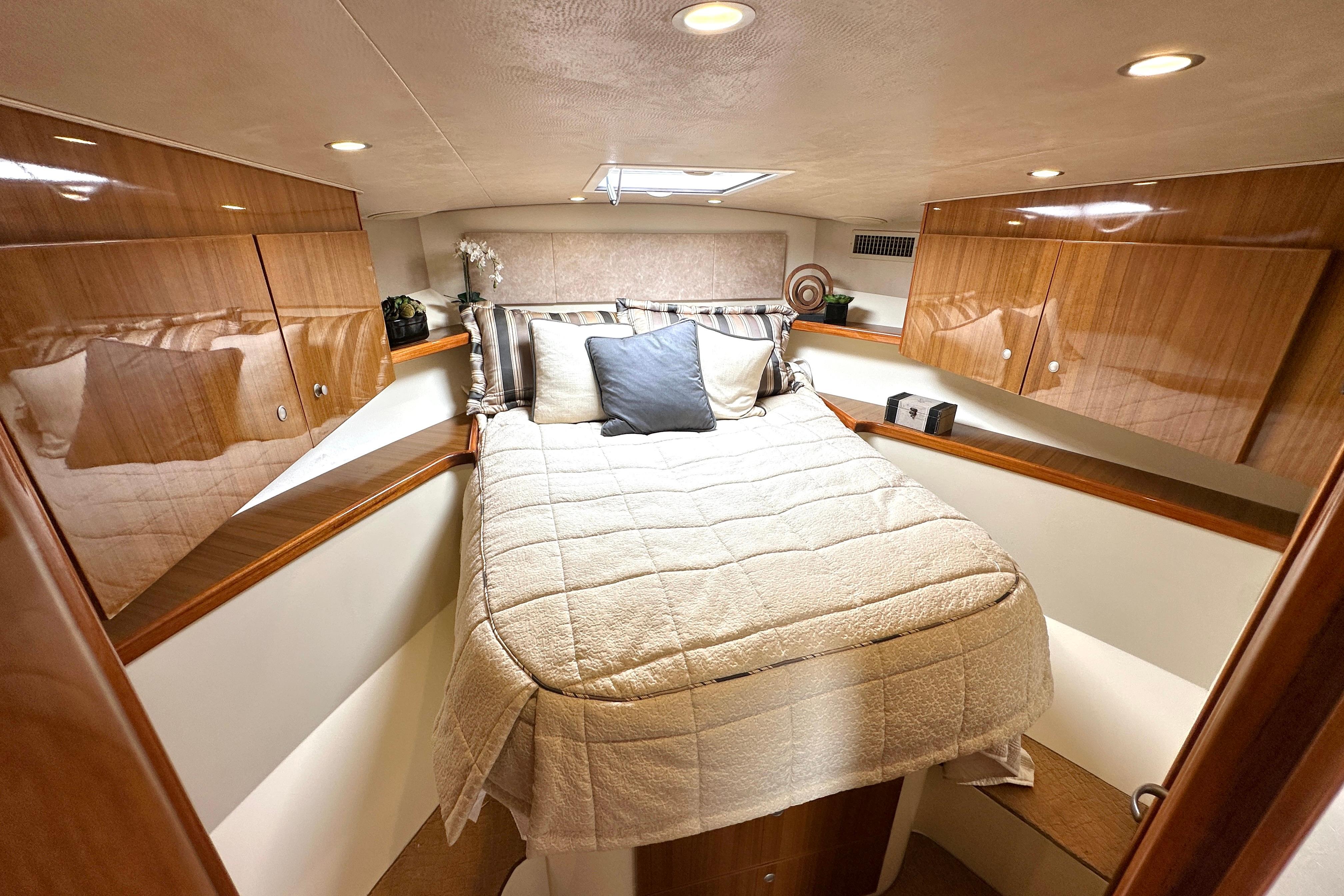 Luxurious cabin interior of 2012 Viking 42 Open yacht with cozy bedding.