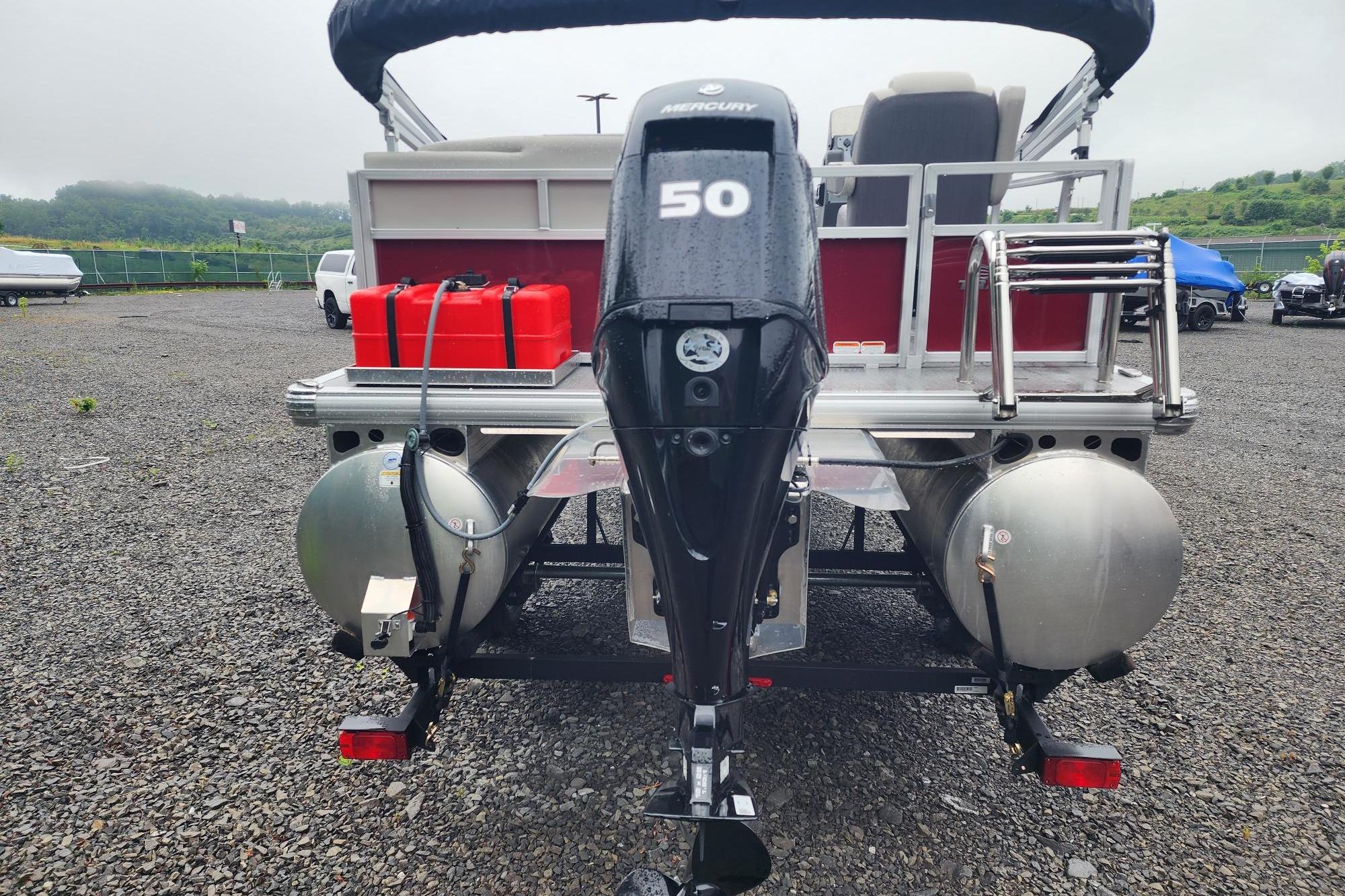 2026 Sun Tracker Bass Buggy 16 XL Select pontoon boat with Mercury 50 engine, rear view.