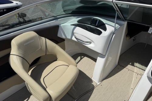 2017 Rinker QX21 BR boat interior with beige seating and sleek dashboard design.