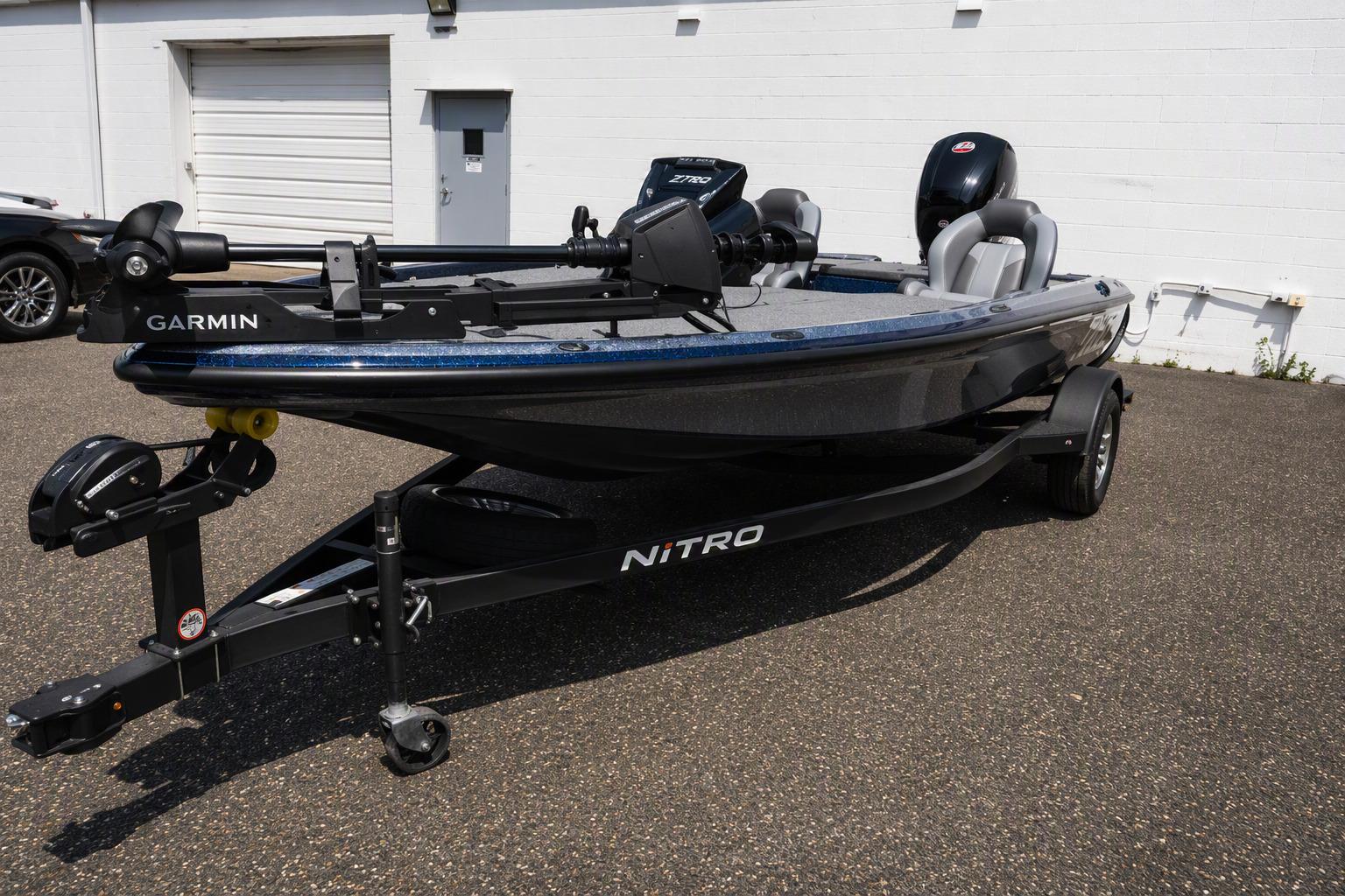 2026 Nitro Z18 Pro fishing boat with Garmin equipment on a trailer, parked outdoors.