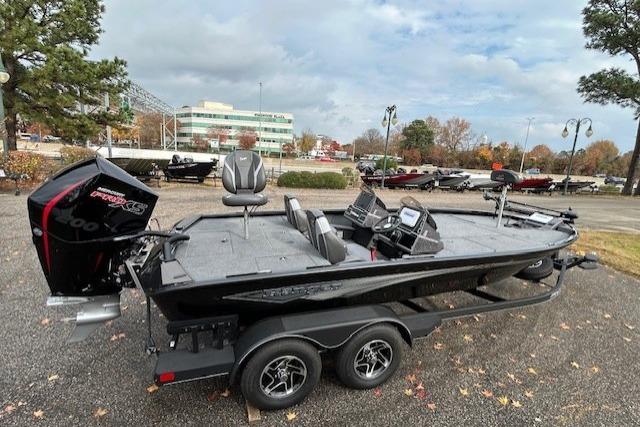 2025 Ranger ALPHA 208 boat on trailer, parked outdoors with trees and buildings in background.