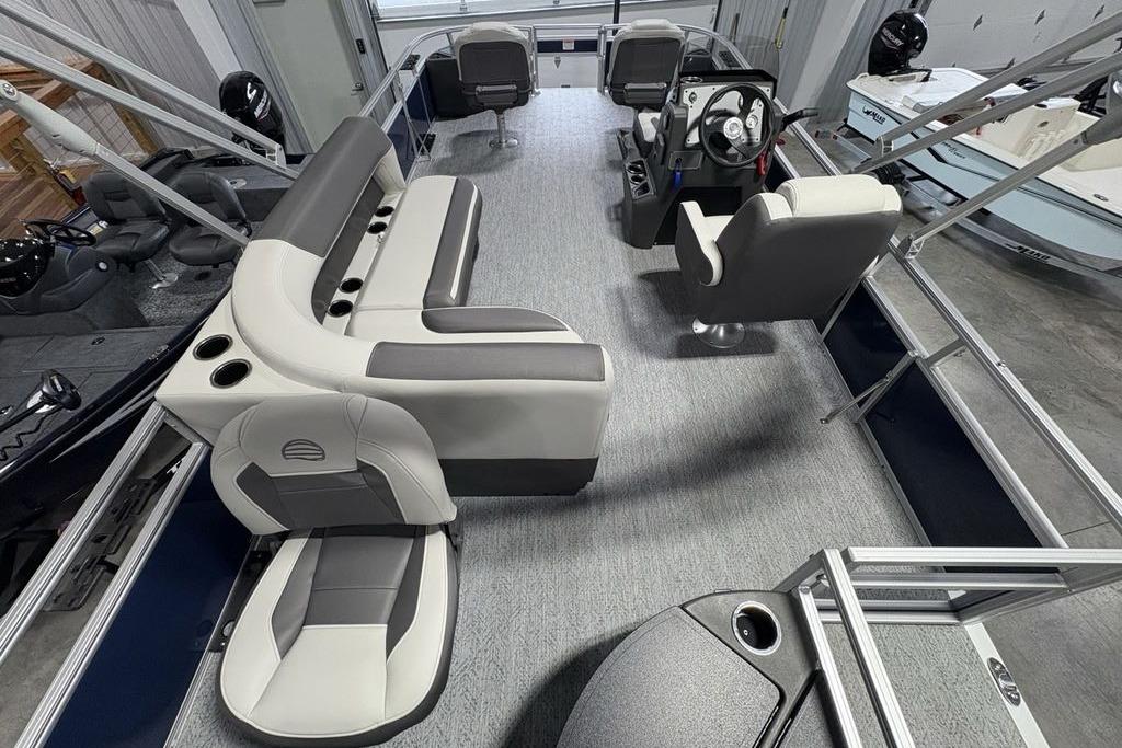 2026 Sun Tracker Bass Buggy 18 DLX pontoon boat interior with seating and steering console.