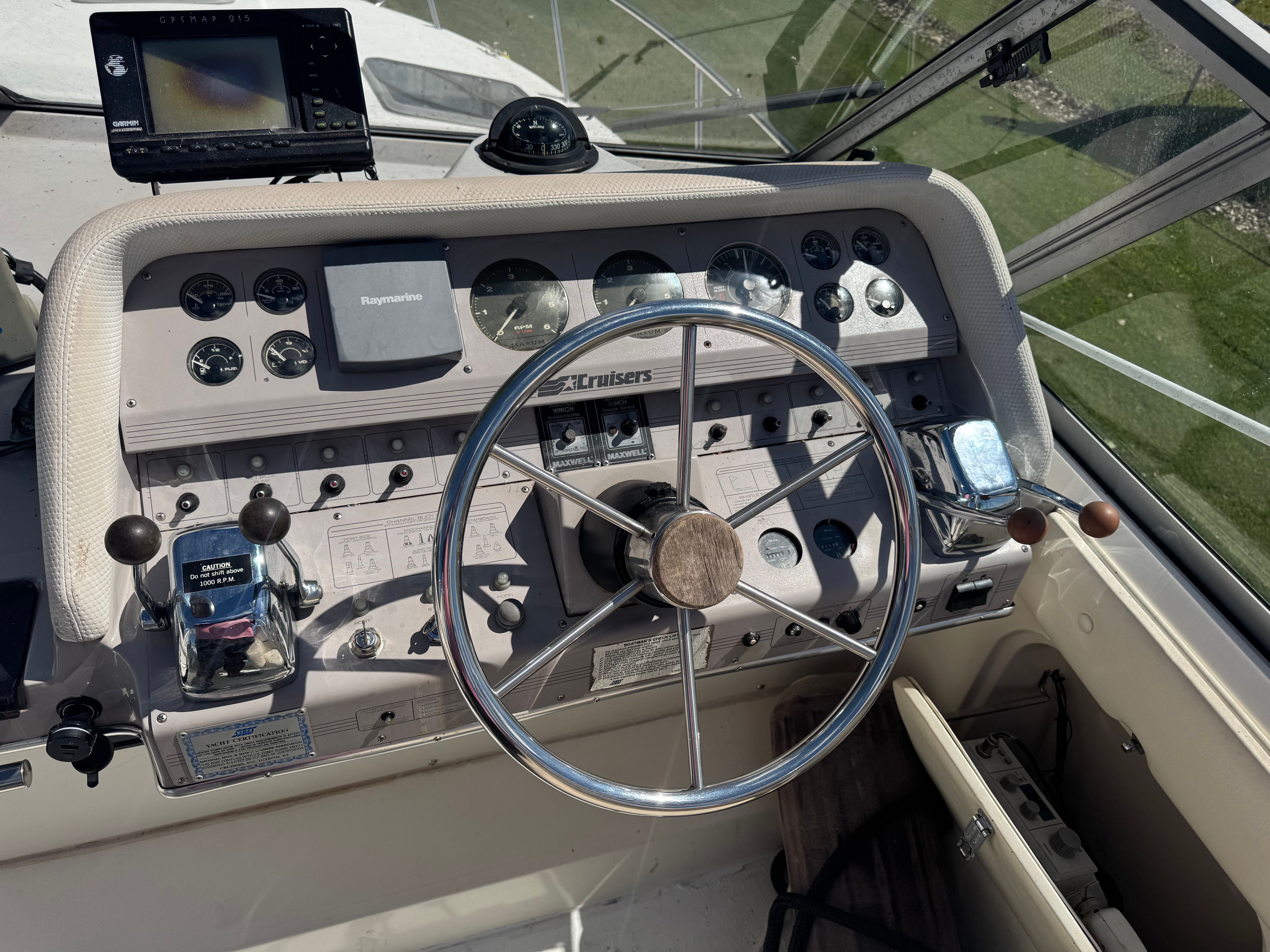 The image shows the helm of a 1992 Cruisers Yachts Esprit 3370 with a large steering wheel and instruments.